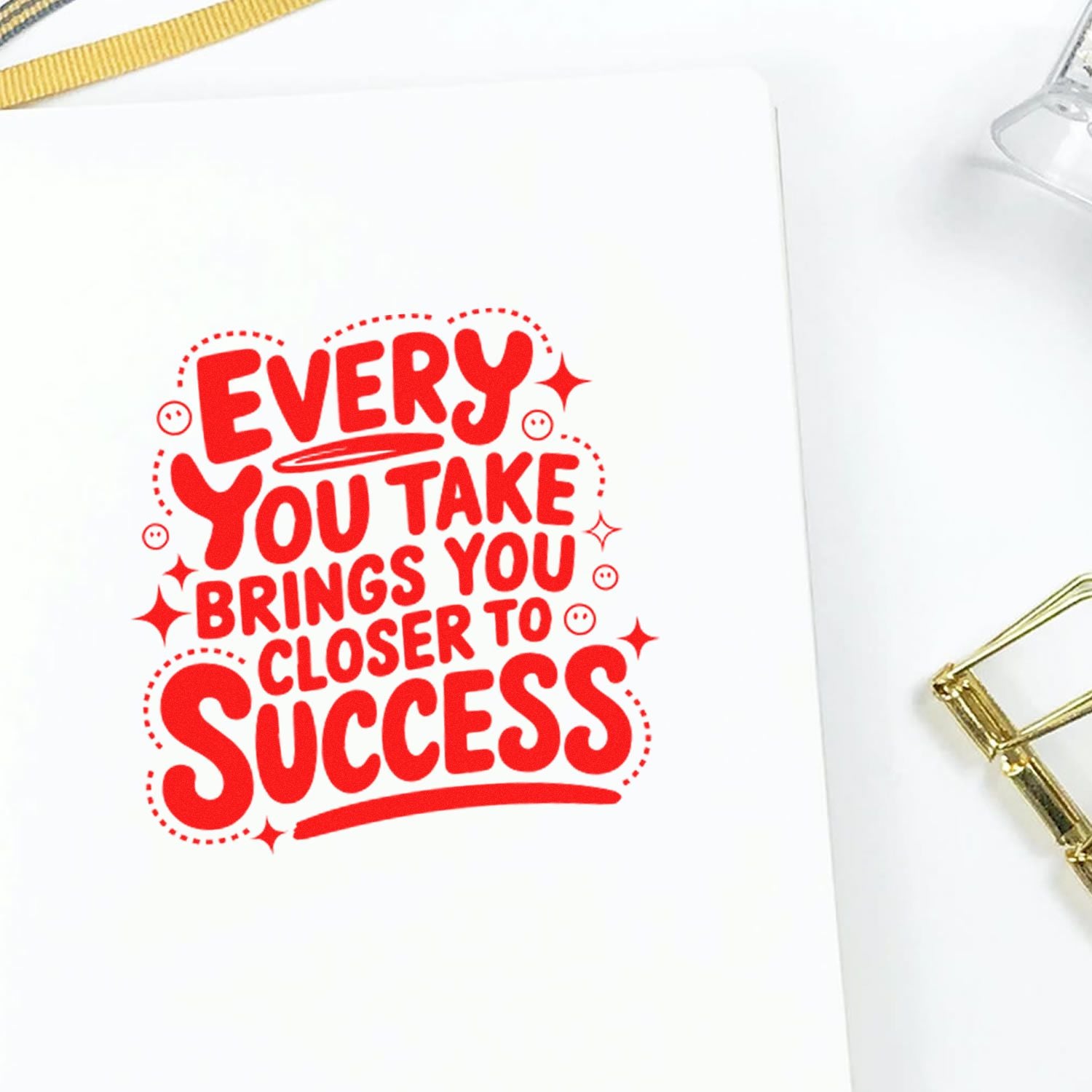Red motivational rubber stamp design reading Every you take brings you closer to success on white paper.
