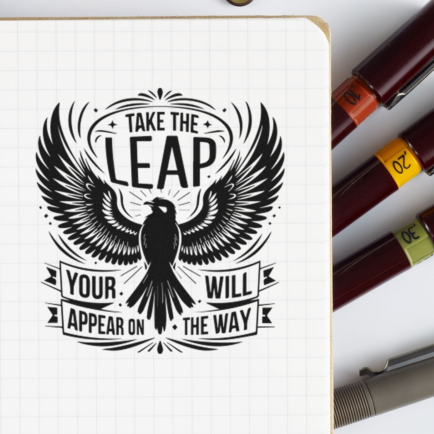 Inspirational custom rubber stamp with eagle and Take the Leap quote on notebook page.