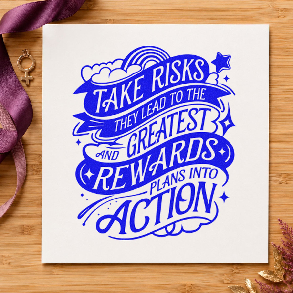 Take Risks Greatest Rewards craft stamp in blue ink on cardstock, an easy option for packing cloth printing.