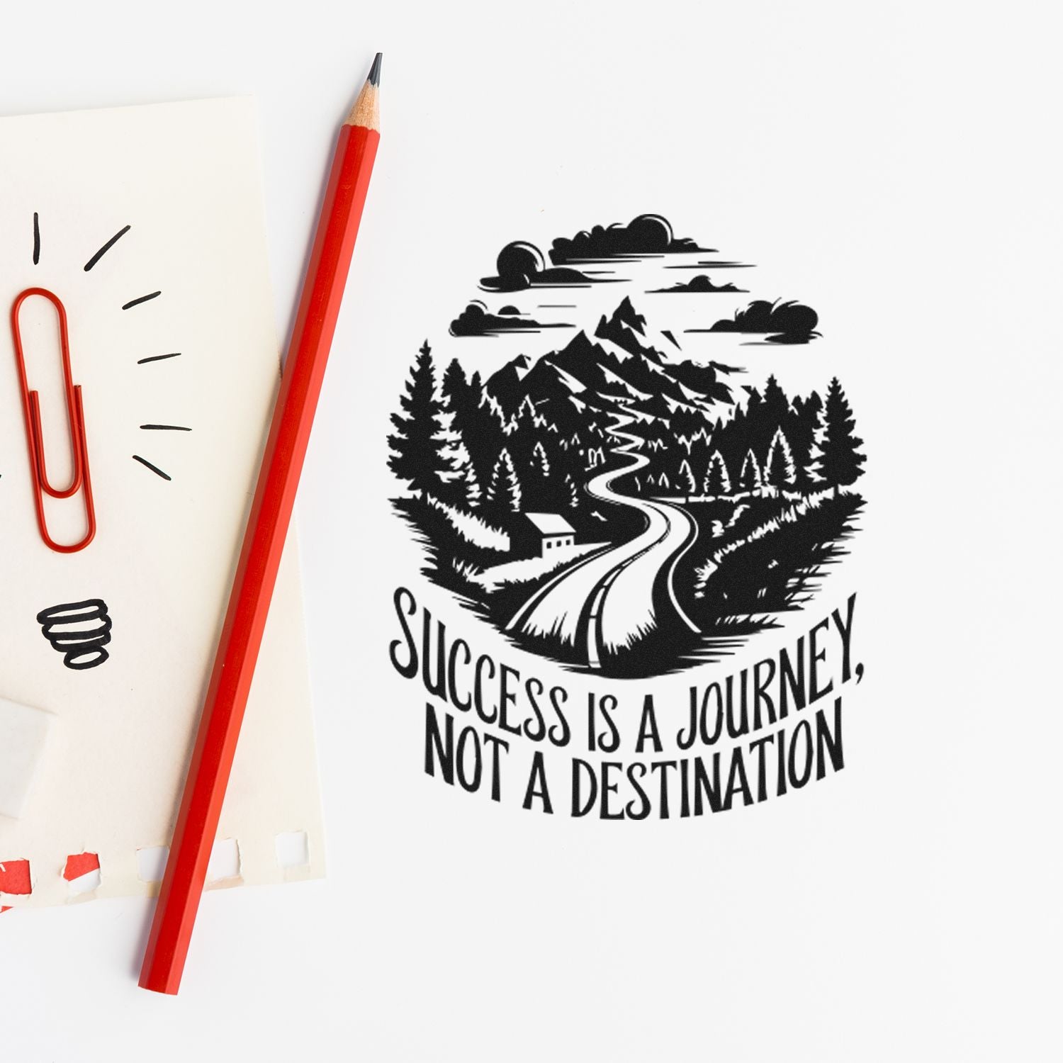 Mountain road rubber stamp with quote Success is a journey, not a destination on paper beside a red pencil.