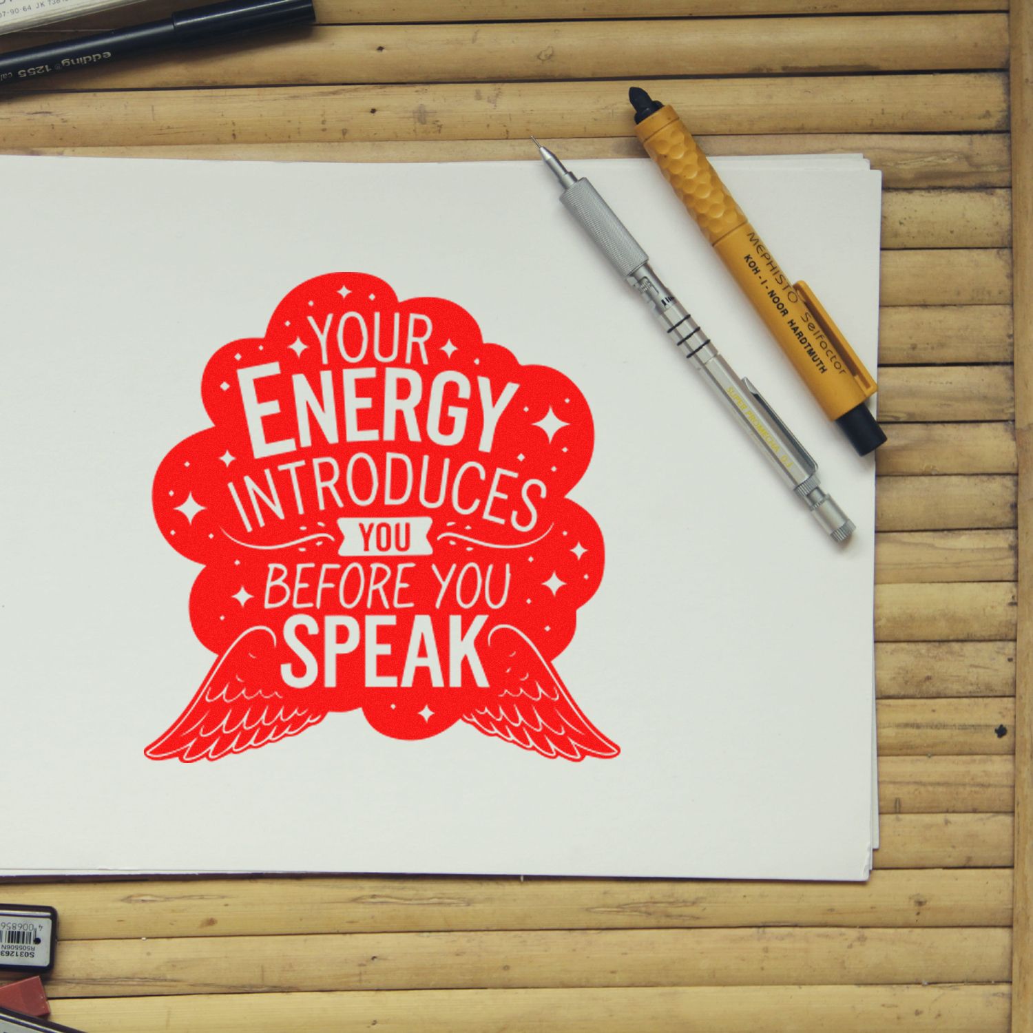 Motivational rubber stamp design with quote Your energy introduces you before you speak on paper, with drafting tools.