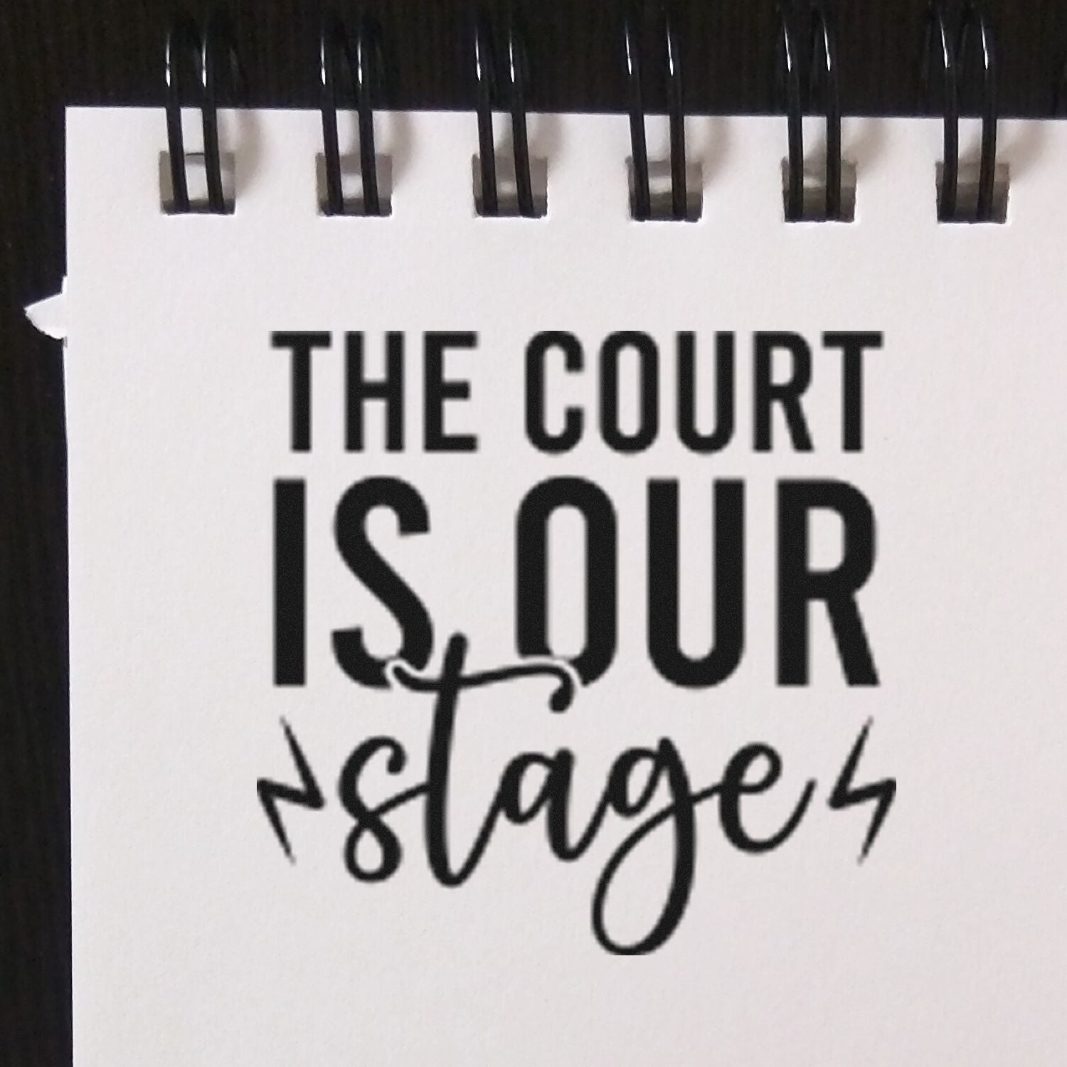 Custom rubber stamp design reading The Court Is Our Stage for tennis, sports, or courtroom-themed branding.