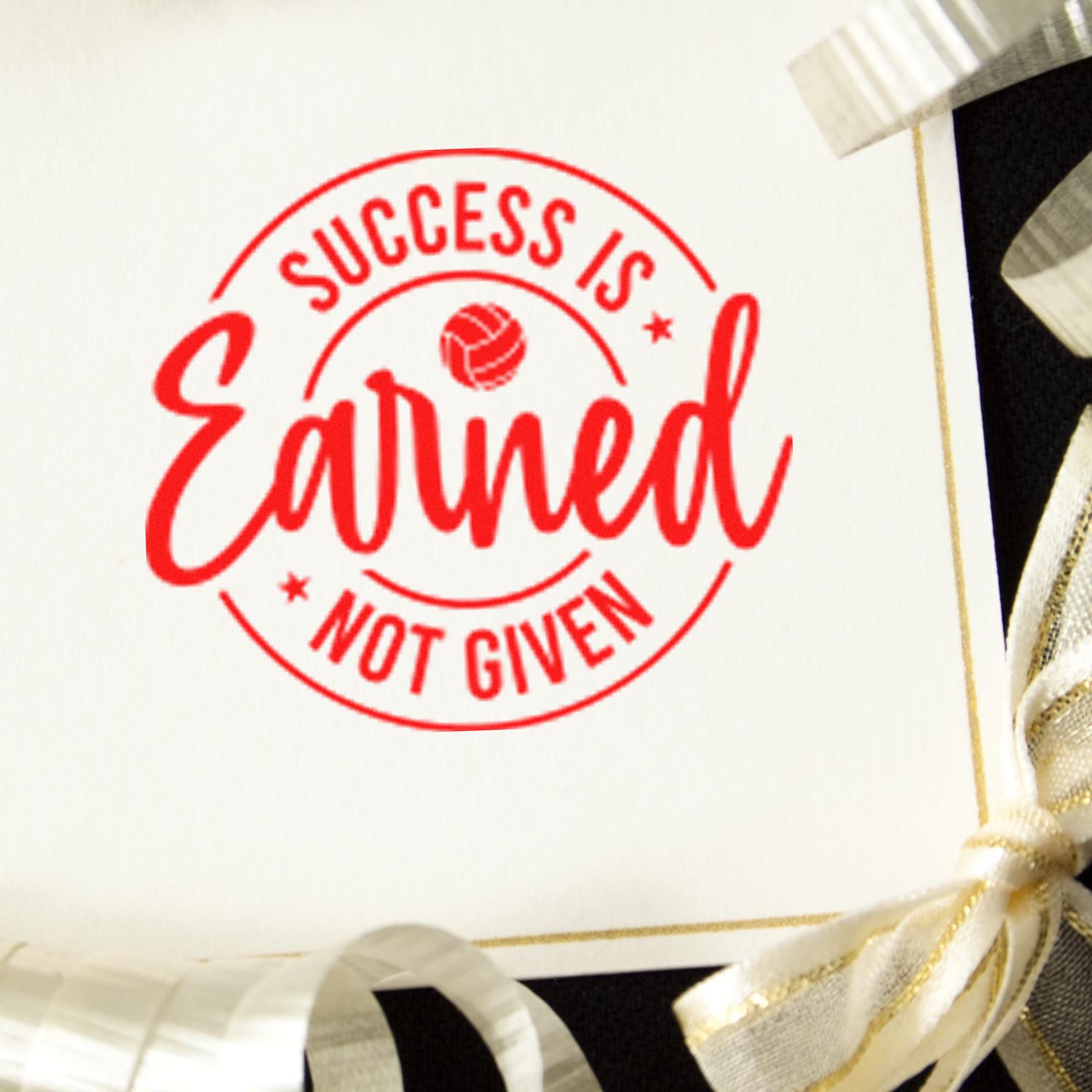 Red Success Is Earned Not Given rubber stamp impression on white card, ideal for motivational business branding.