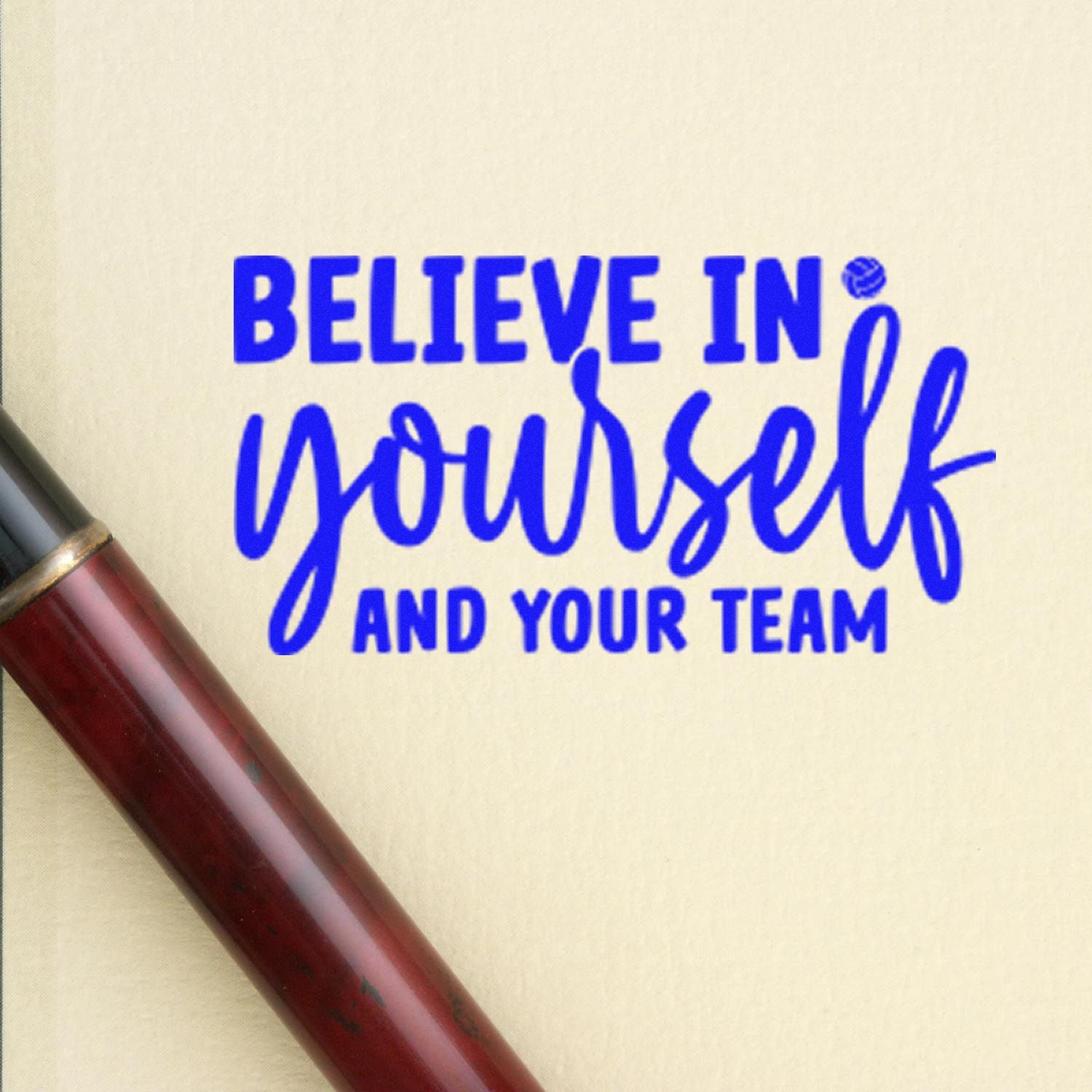 Motivational rubber stamp impression reading Believe in yourself and your team in blue ink for team encouragement.