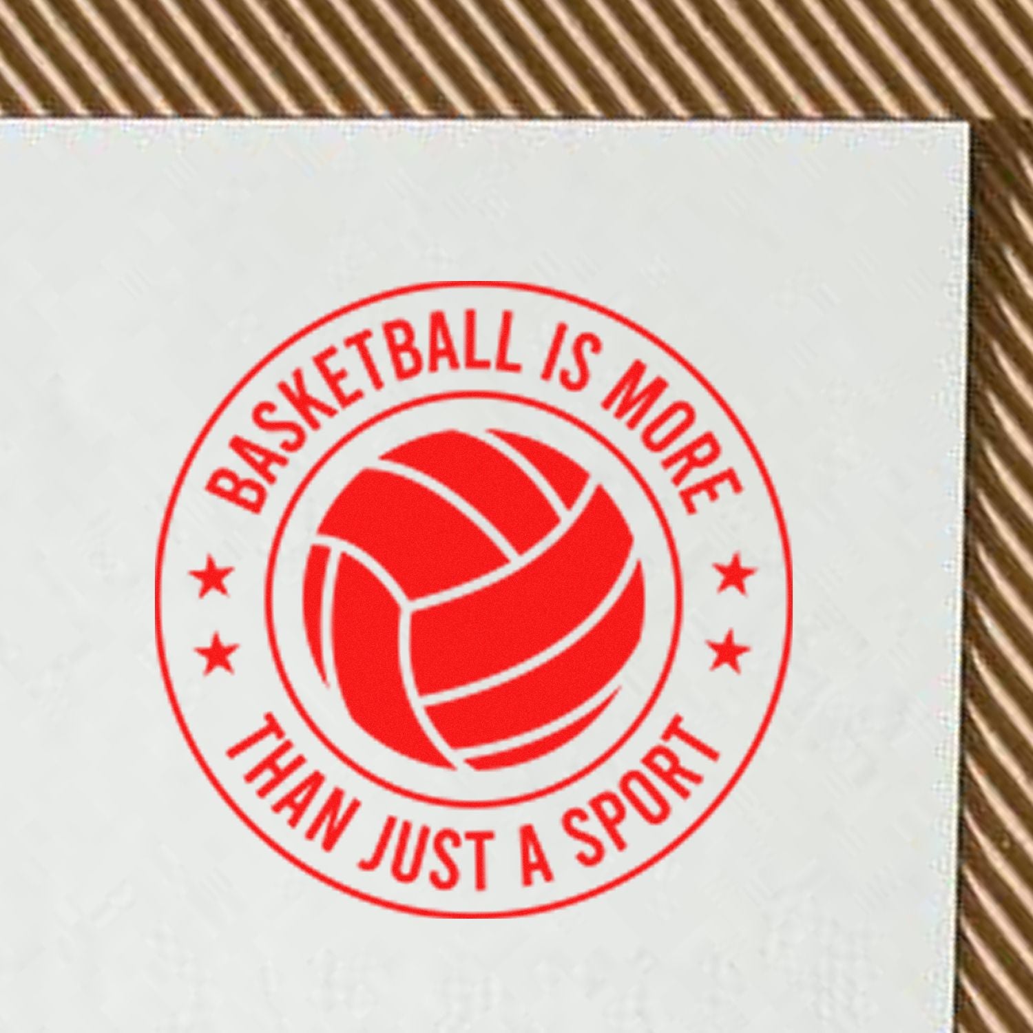 Red basketball rubber stamp impression with circular logo and slogan, Basketball Is More Than Just a Sport.