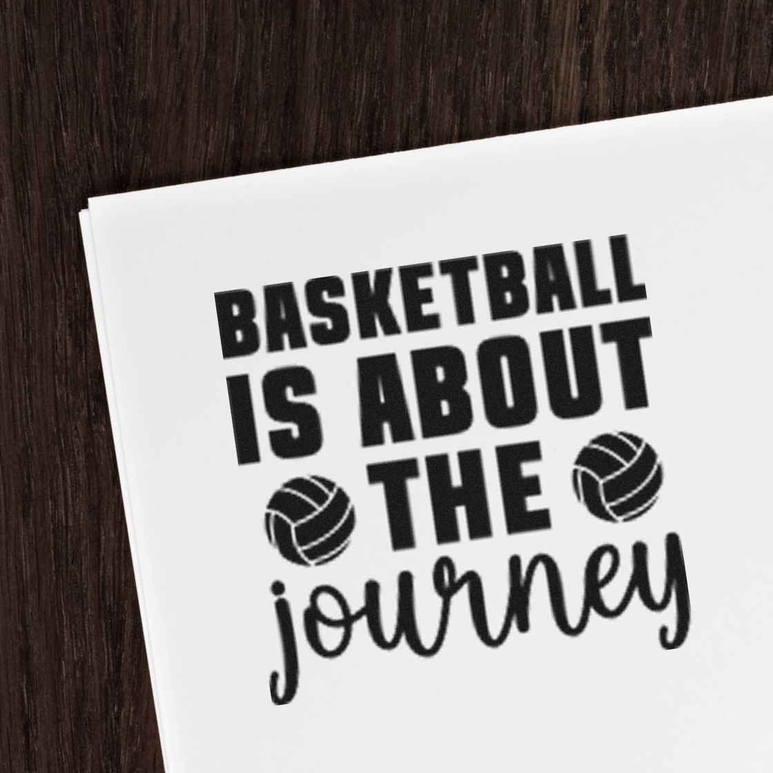 Inspirational basketball is about the journey rubber stamp design with basketball icons on white paper.