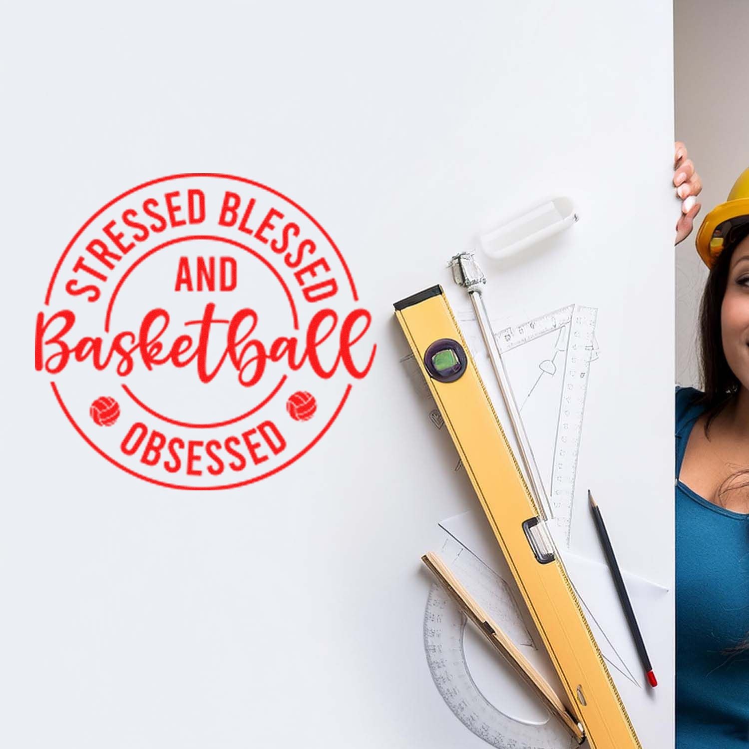 Custom rubber stamp design reading Stressed Blessed and Basketball Obsessed on a white board with drafting tools and ruler.