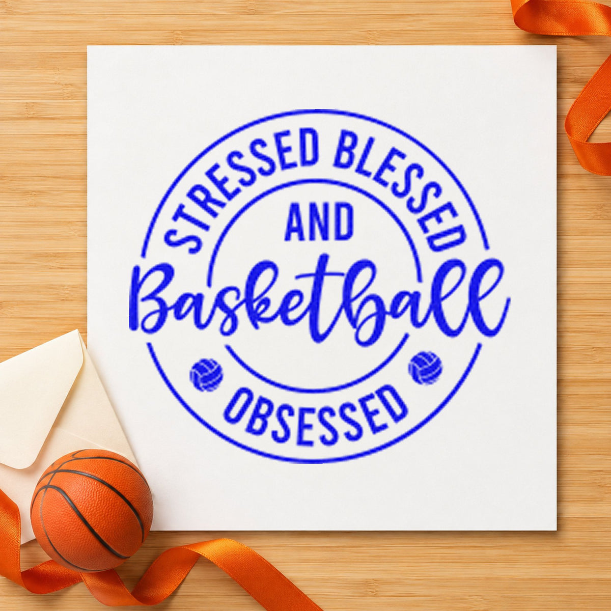 Stressed Blessed Basketball Obsessed craft stamp imprinted in blue ink on paper, a design suited to framed kitchen board.