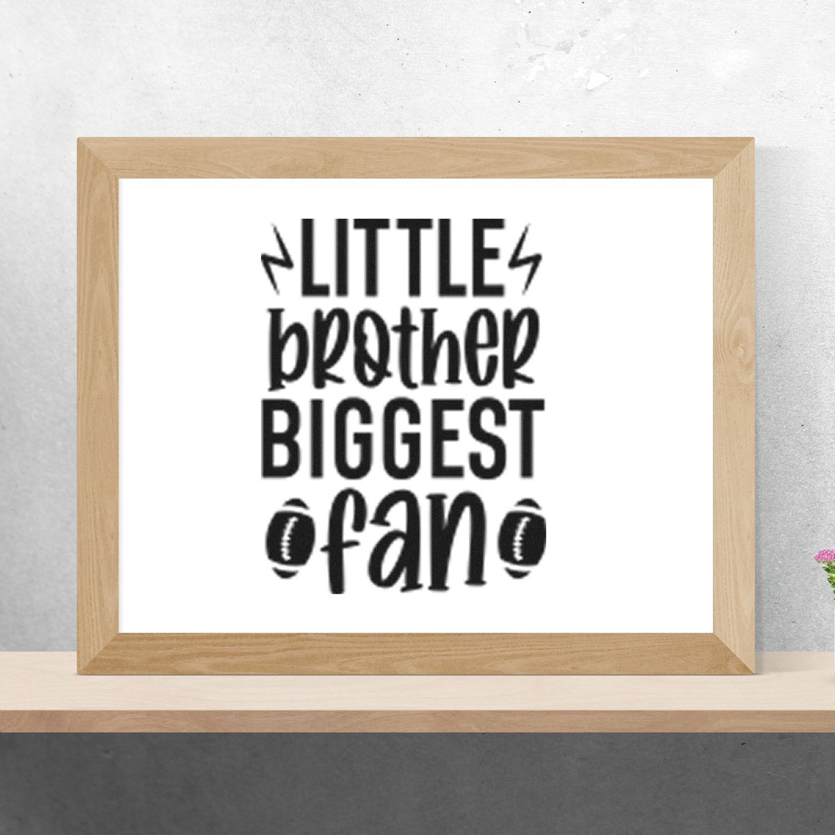 Little Brother Biggest Fan Premium Wooden Stamp - Vintage Pro imprint stamped in black ink. LITTLE brother BIGGEST fan appears with lightning bolts and two footballs.