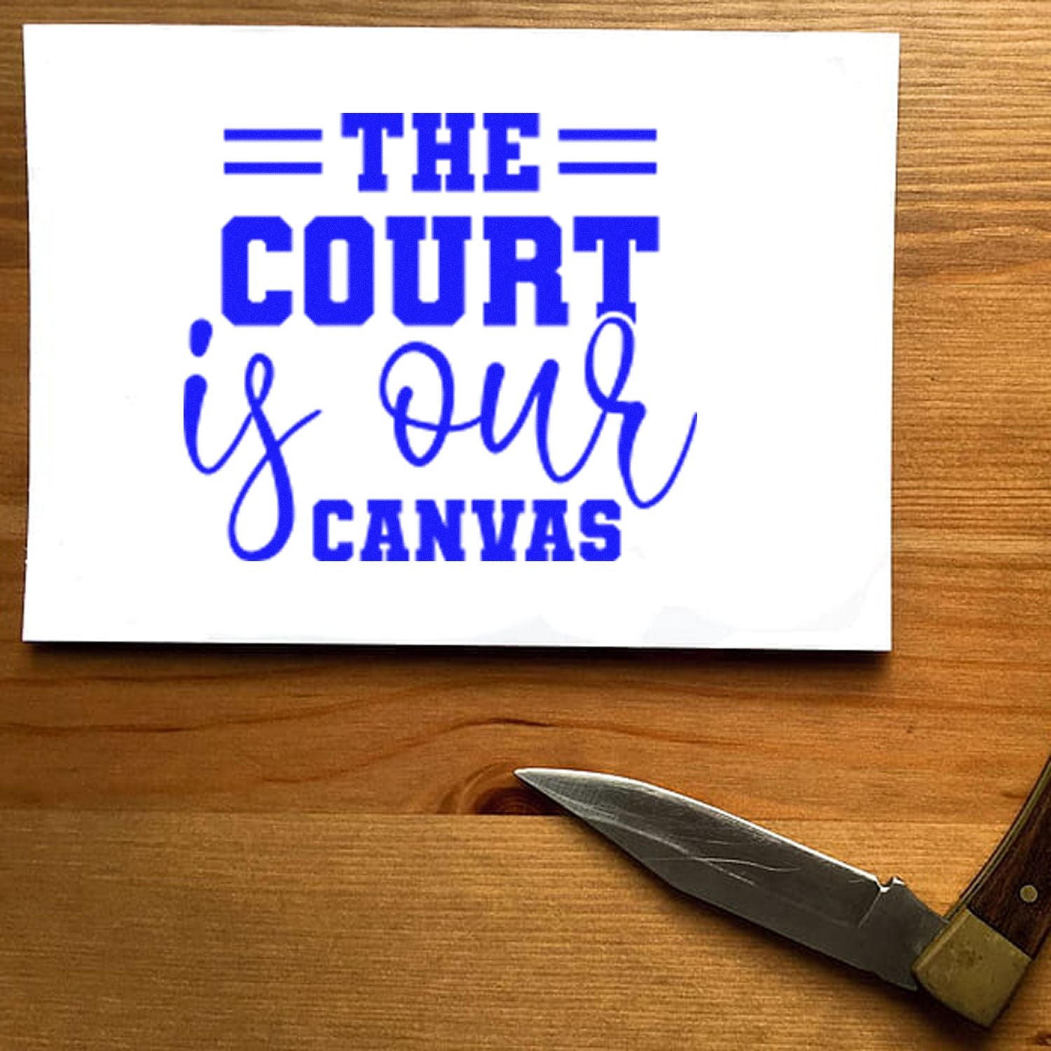 Blue rubber stamp design reading The Court Is Our Canvas for lawyer stationery and legal gifts.