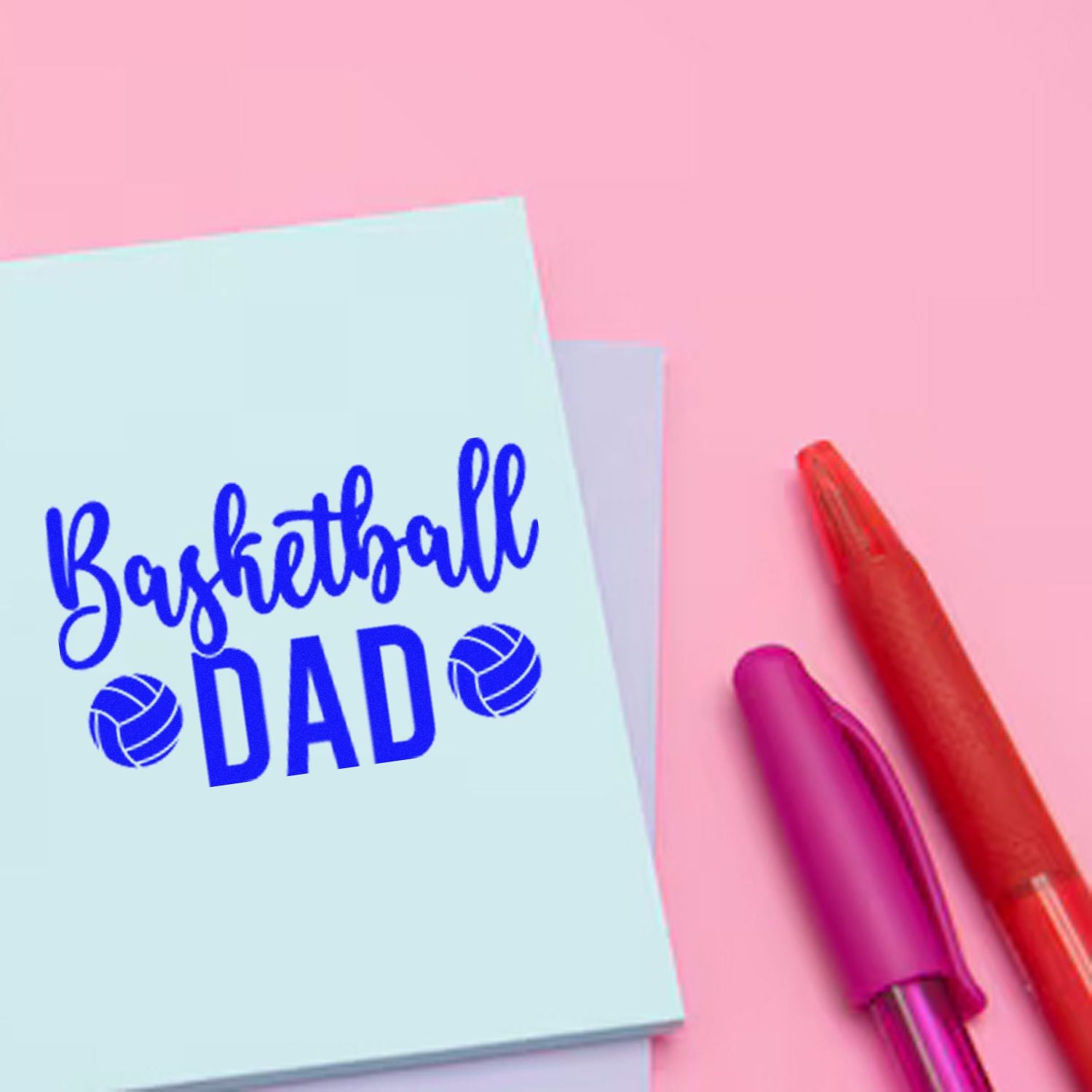 Basketball Dad rubber stamp design on card with pens, ideal for Fathers Day crafts, sports gifts, and custom stationery.