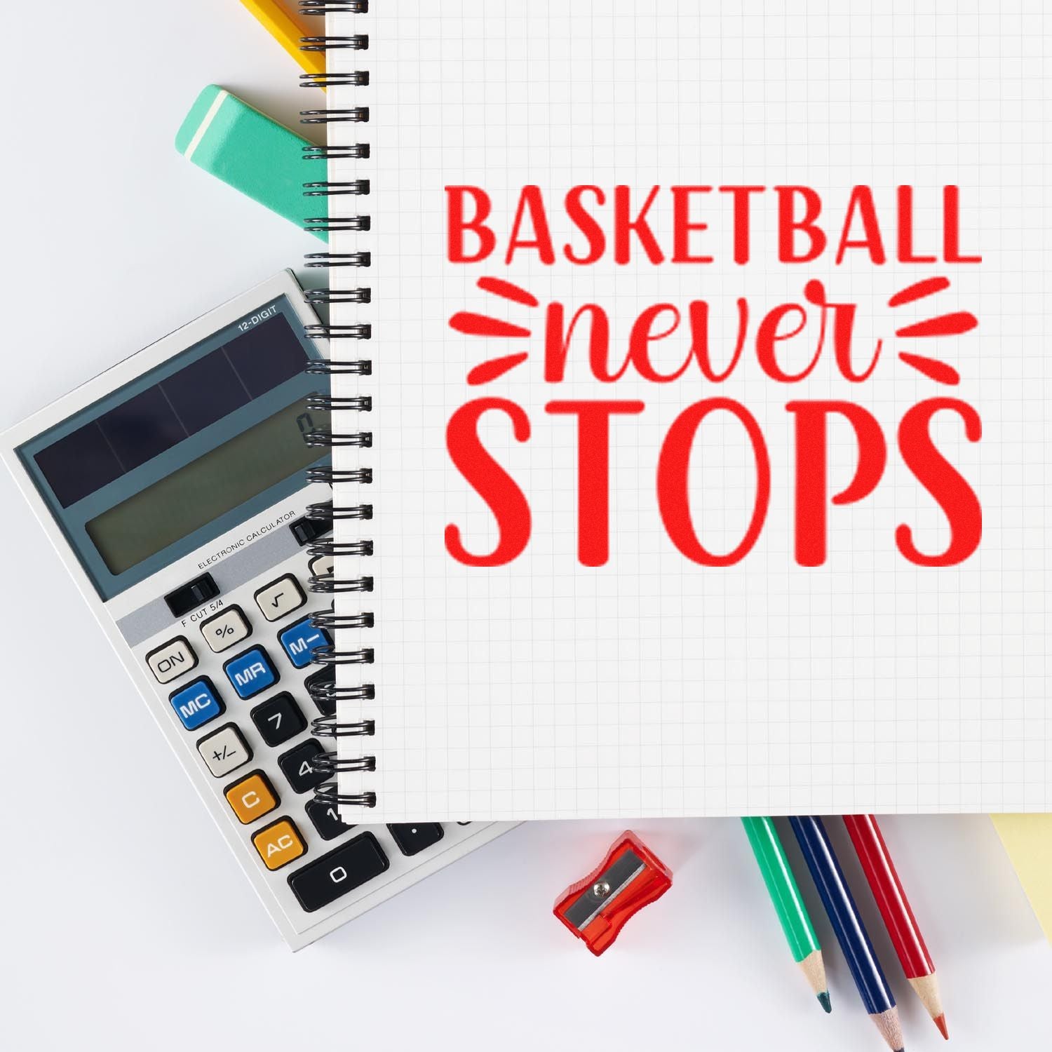 Basketball never stops rubber stamp in red on notebook, with calculator and pencils for sports-themed planning and notes.