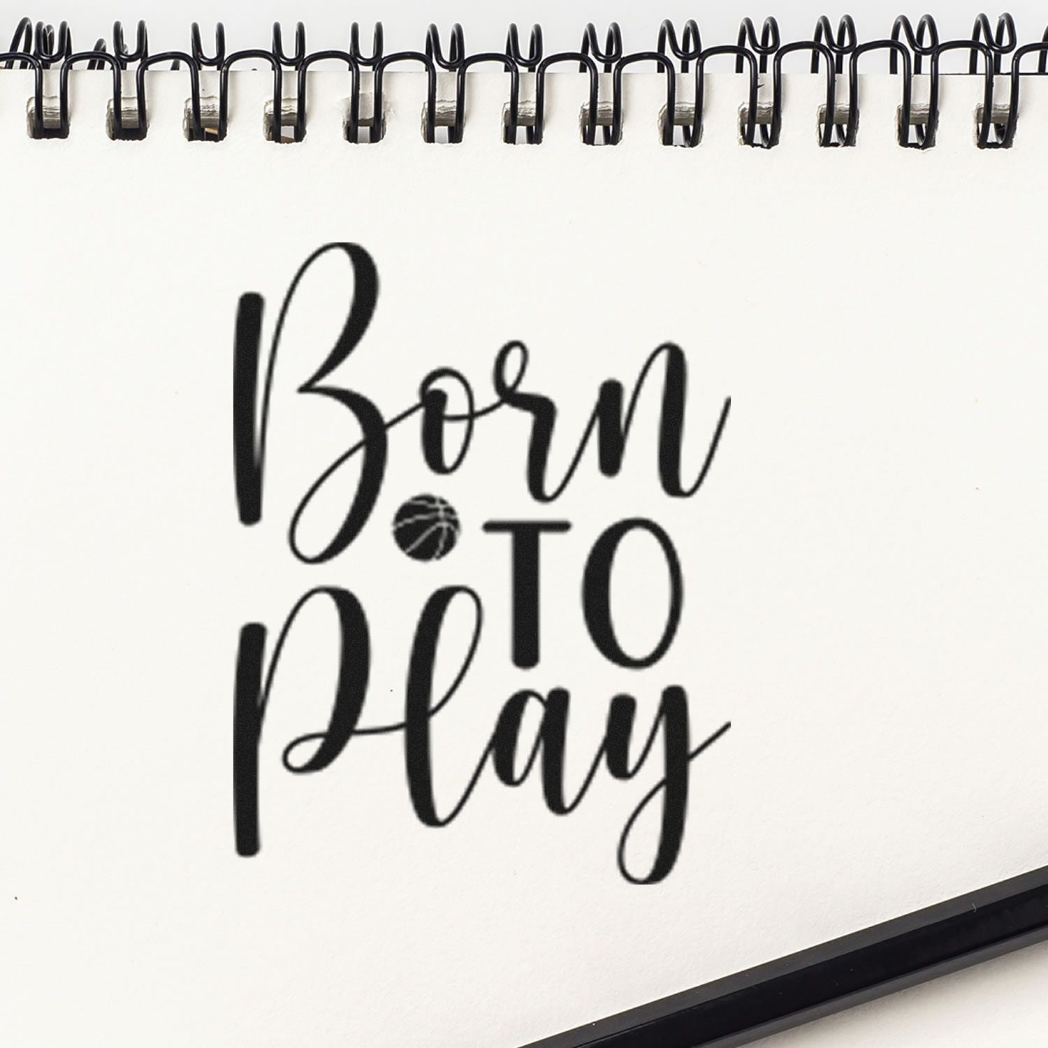 Born to Play basketball-themed rubber stamp design on spiral notebook page