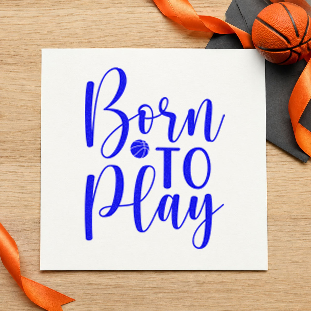 Born To Play Basketball craft stamp imprinted in blue ink on paper, a design suited to framed nursery shelf.