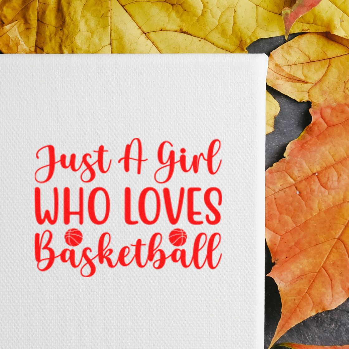 Basketball rubber stamp with Just a Girl Who Loves Basketball in red script on white cardstock with autumn leaves.