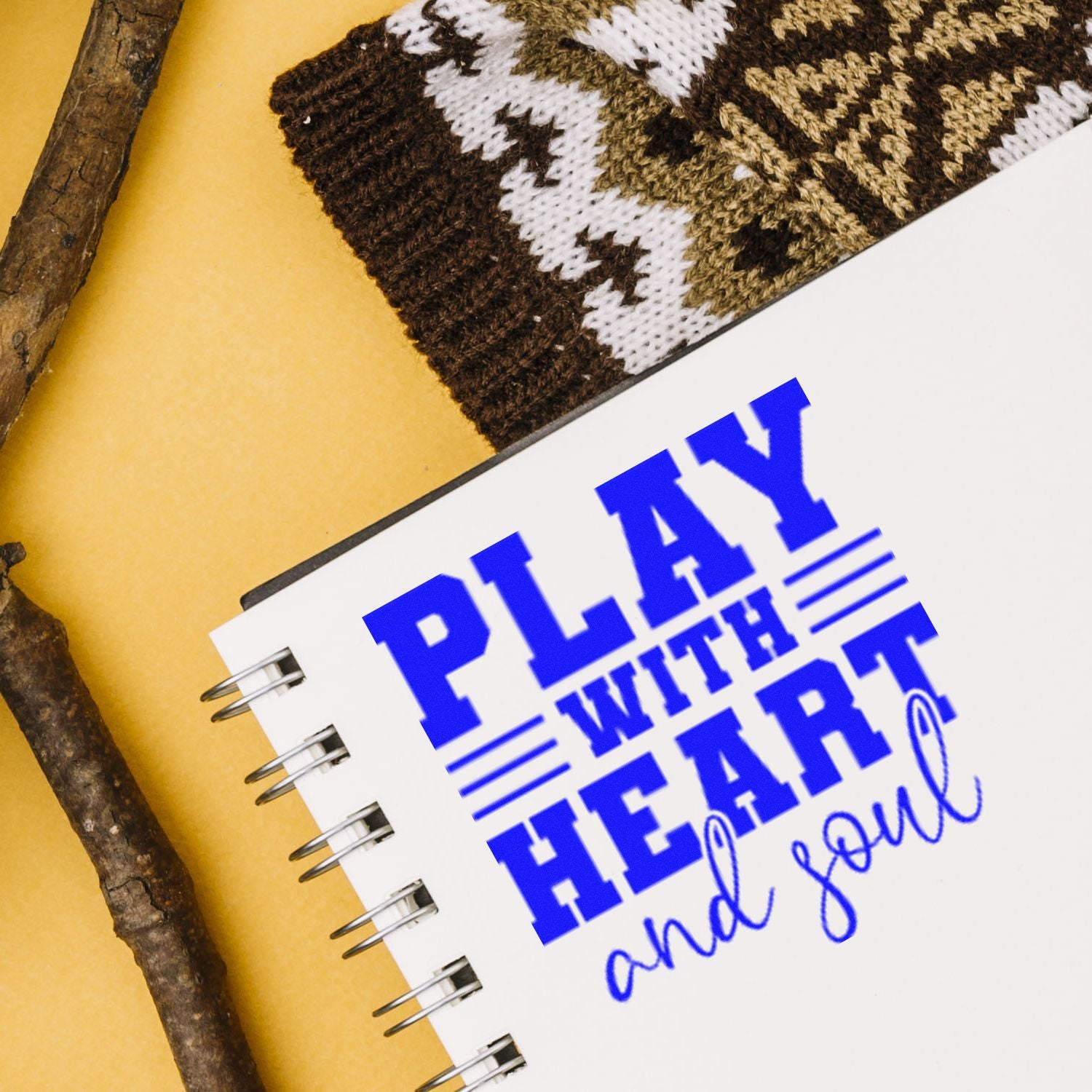Blue Play With Heart and Soul rubber stamp design on notebook page for DIY crafts and personalized stationery.