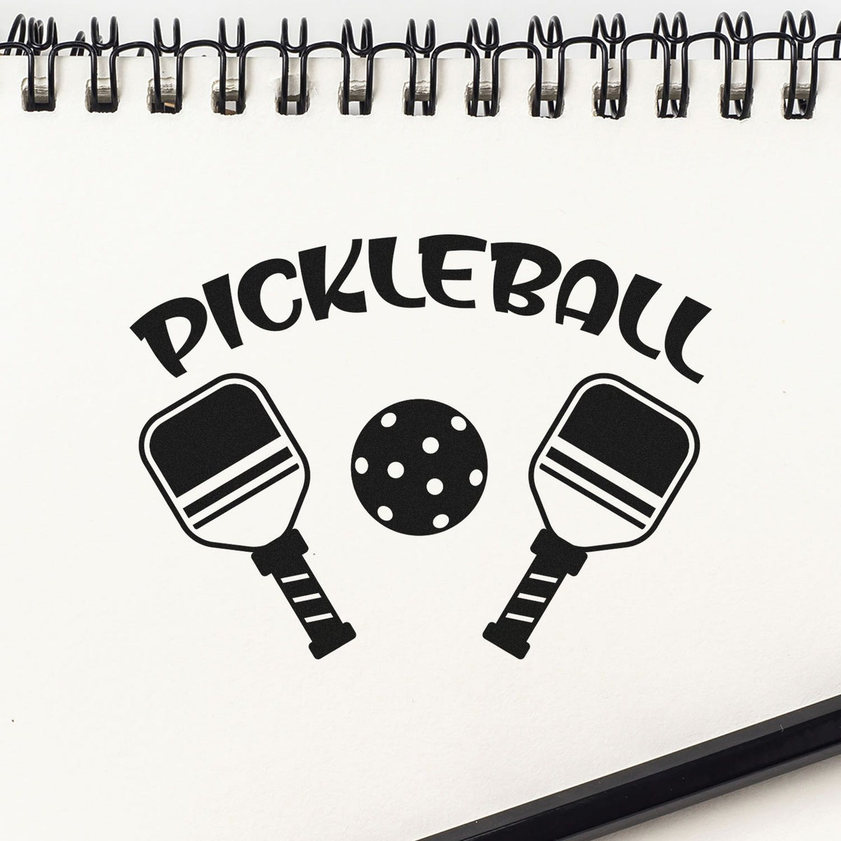 Pickleball Paddles And Ball Premium Wooden Stamp - Vintage Pro imprint stamped in black ink. PICKLEBALL curves above two angled paddles flanking a perforated ball.