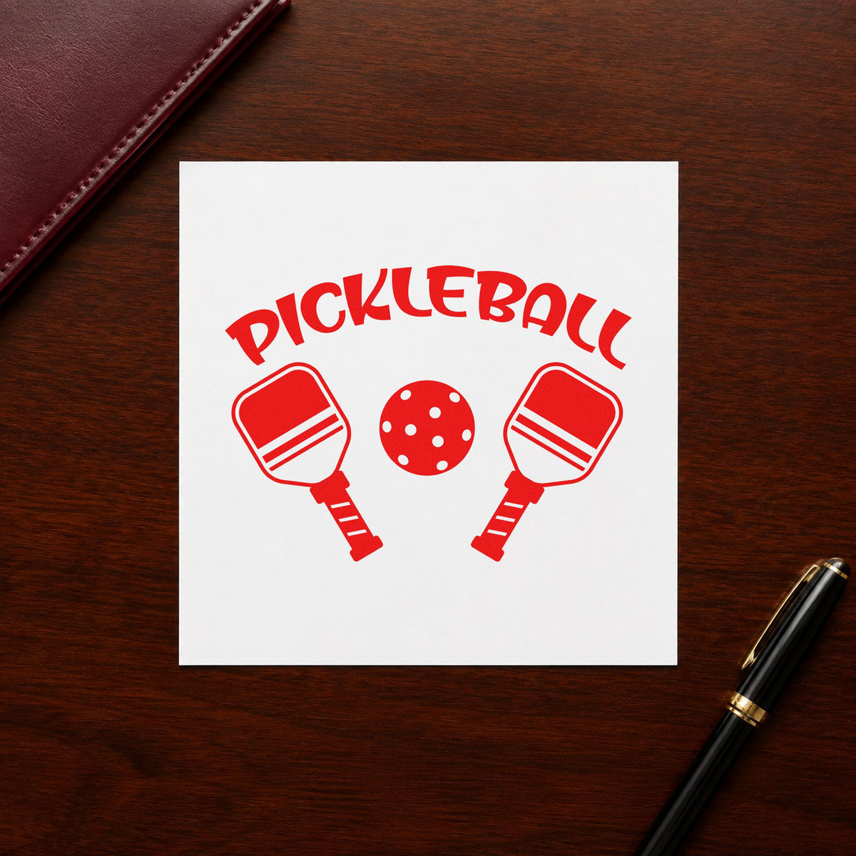 Pickleball Paddles And Ball craft stamp imprint in red ink on a handmade project, one idea being play rule cards.