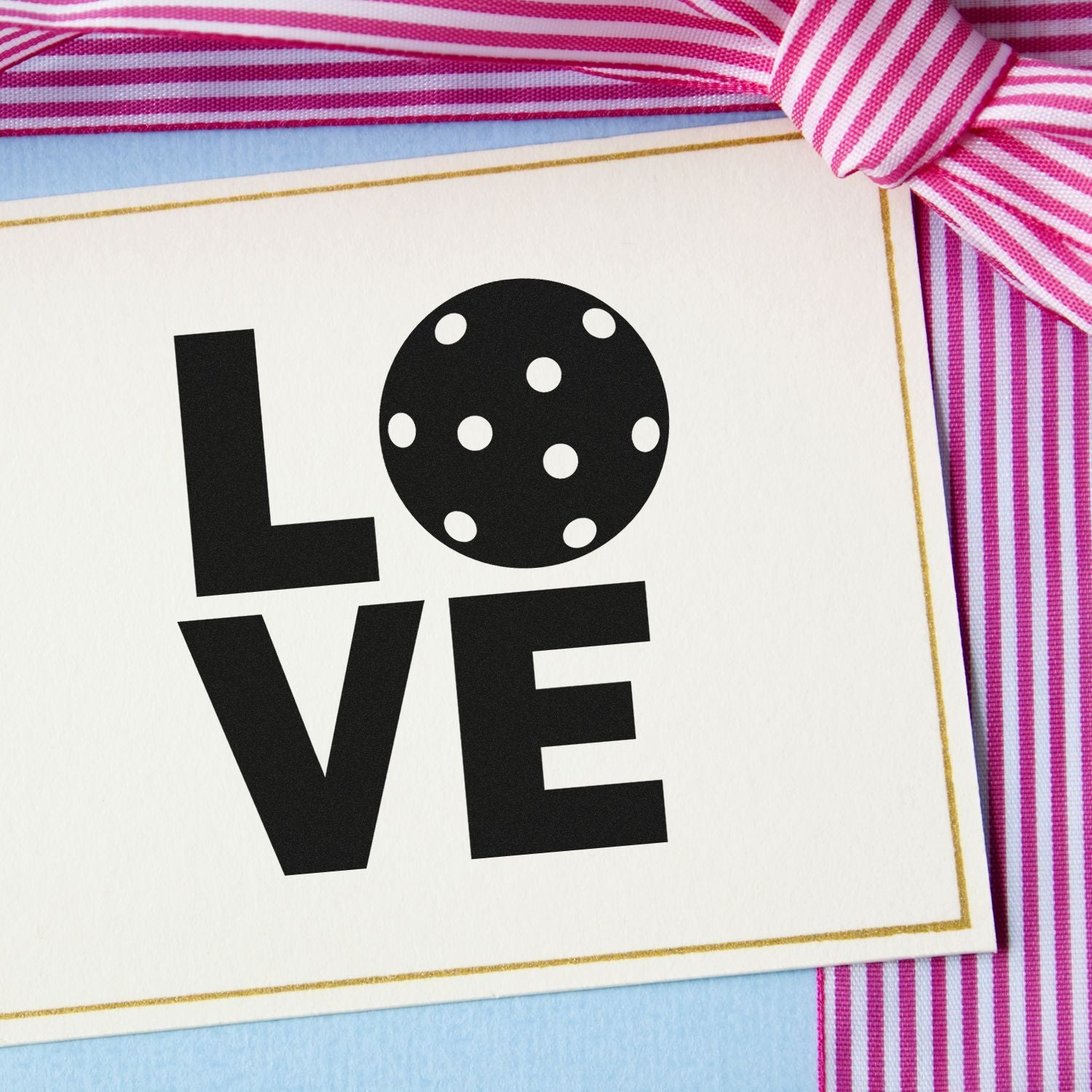 Love rubber stamp design on greeting card with ribbon, ideal for Valentines Day, weddings, and handmade stationery.