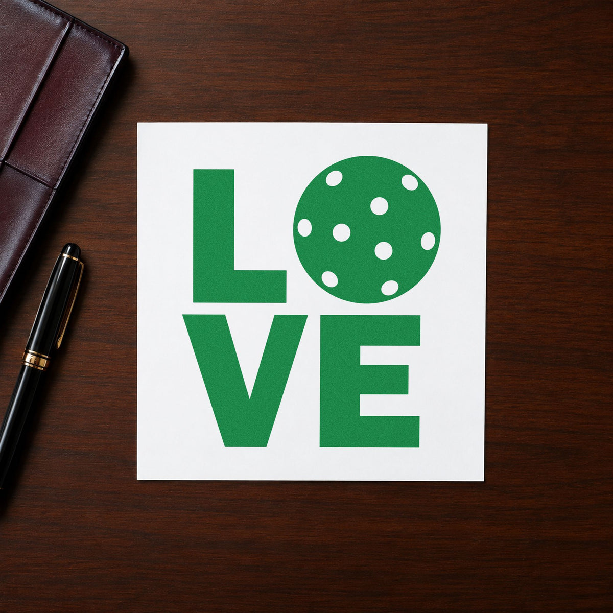 Stacked Love Pickleball Ball craft stamp imprint in green ink on a handmade project, one idea being partner draw cards.