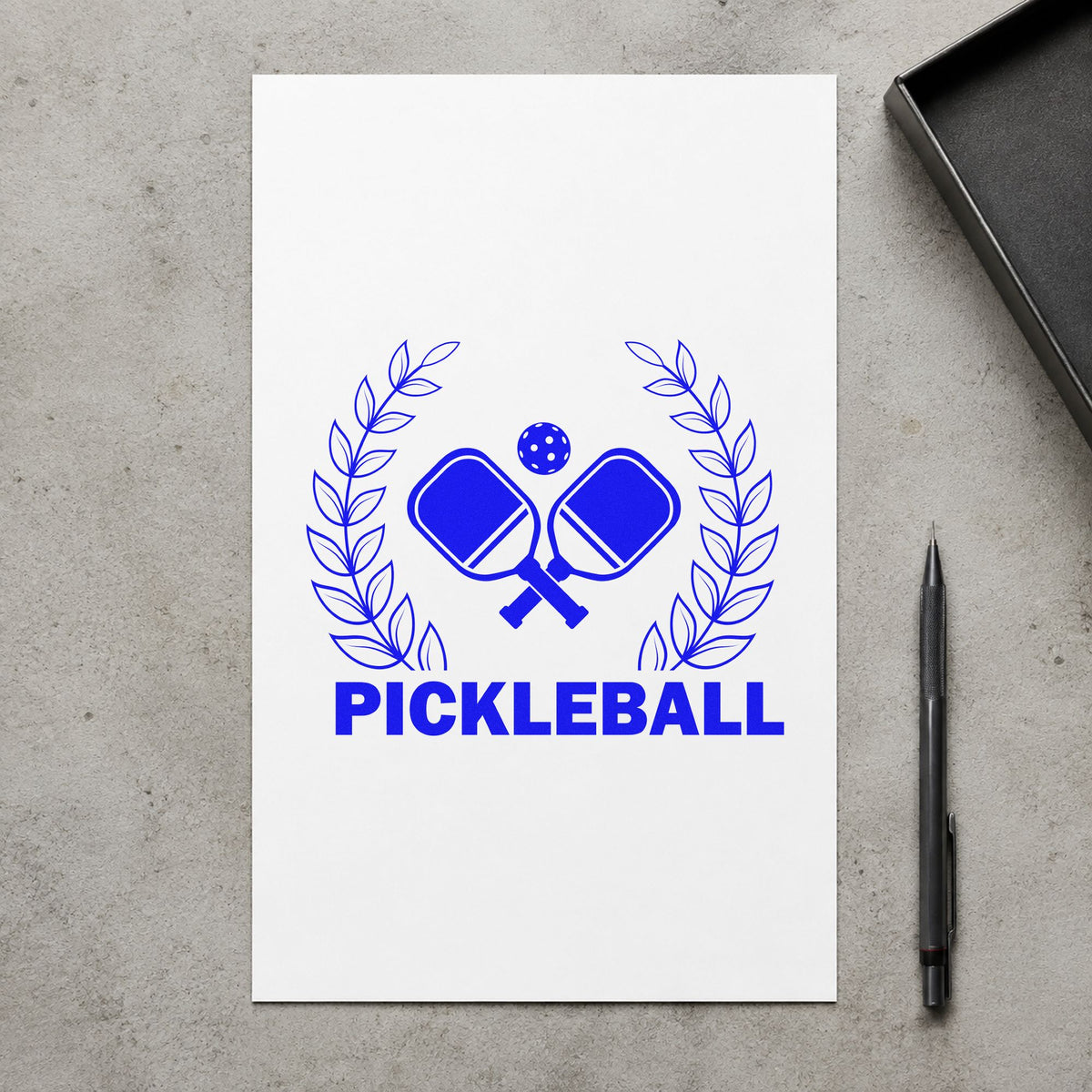 Pickleball Laurel Paddle Badge craft stamp imprinted in blue ink on paper, a design suited to framed venue entry.