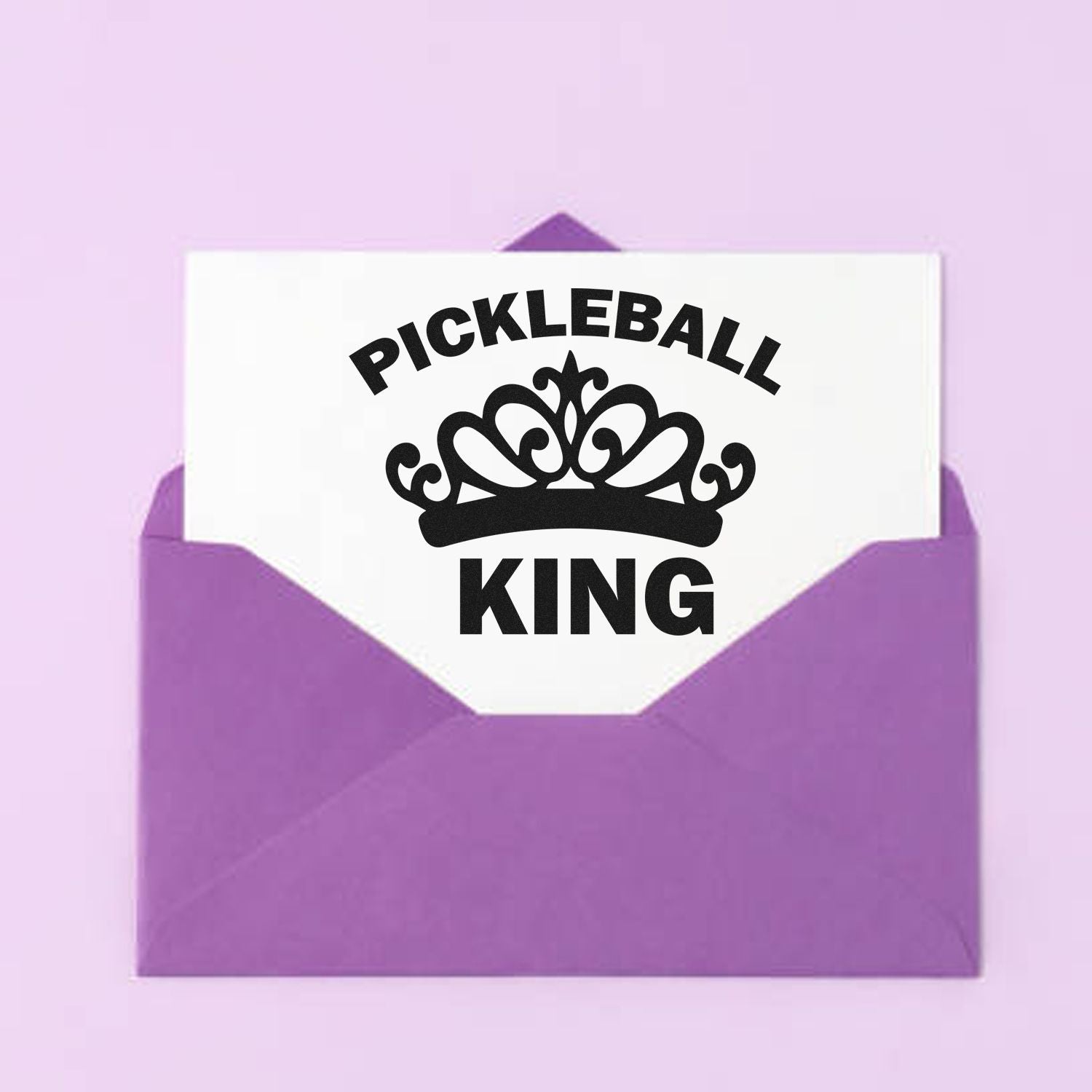Pickleball King rubber stamp design with crown, shown on a white card in a purple envelope.