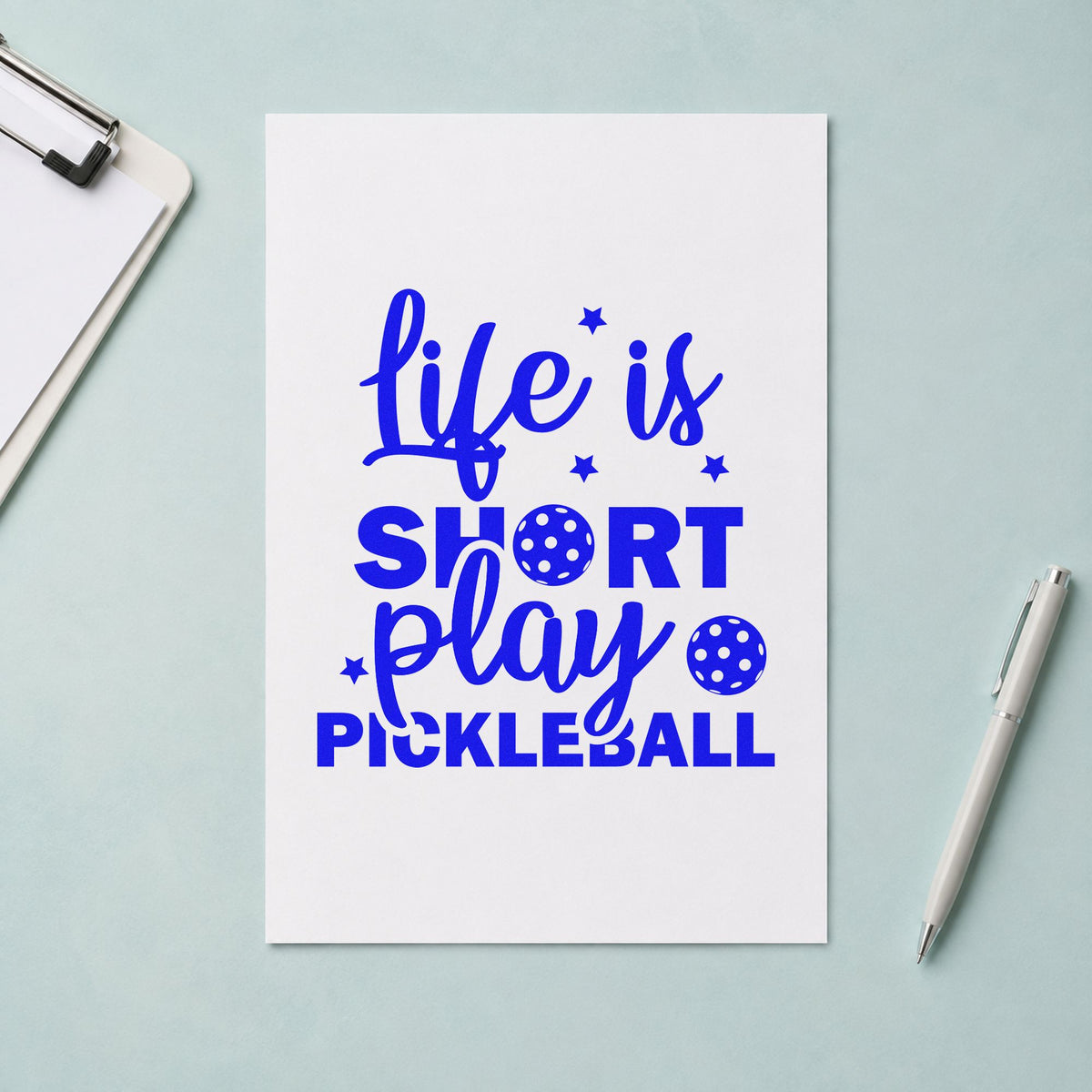 Life Short Play Pickleball craft stamp imprinted in blue ink on paper, a design suited to framed community room.