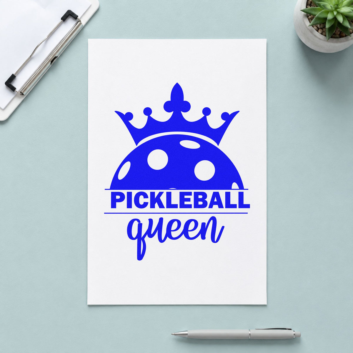 Pickleball Queen Crowned Ball craft stamp imprinted in blue ink on paper, a design suited to framed home hall.