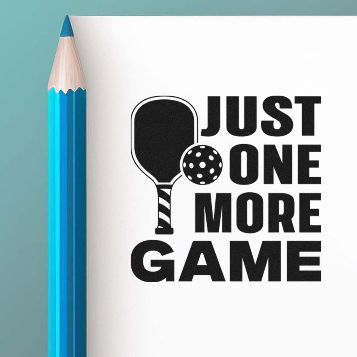 Just One More Game Premium Wooden Stamp - Vintage Pro imprint stamped in black ink. JUST ONE MORE GAME appears beside a pickleball paddle and perforated ball.