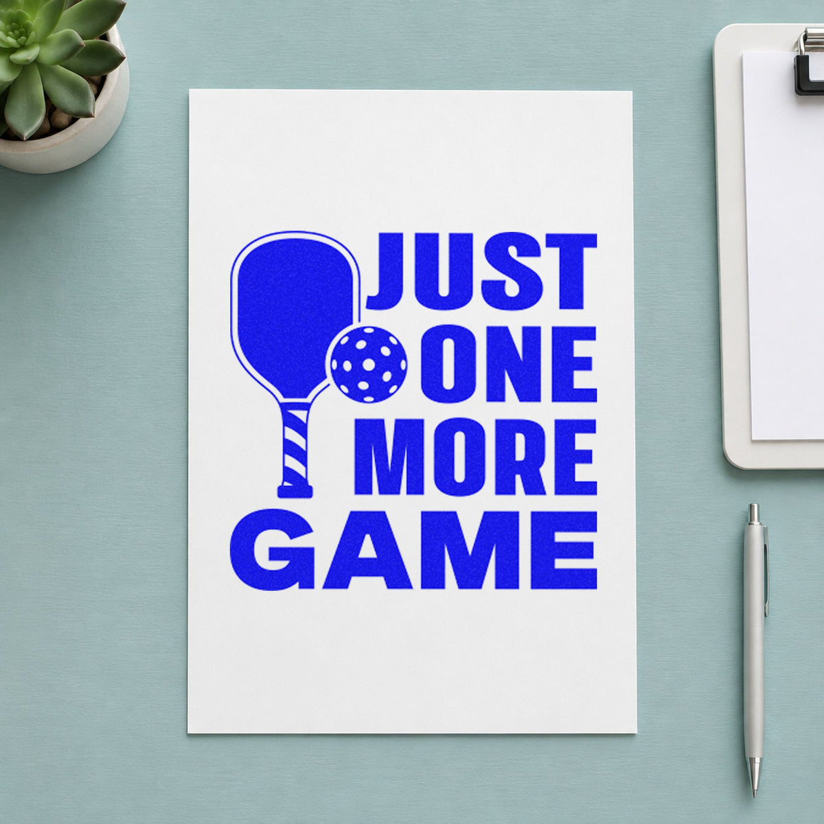 Just One More Game craft stamp imprinted in blue ink on paper, a design suited to framed office locker.