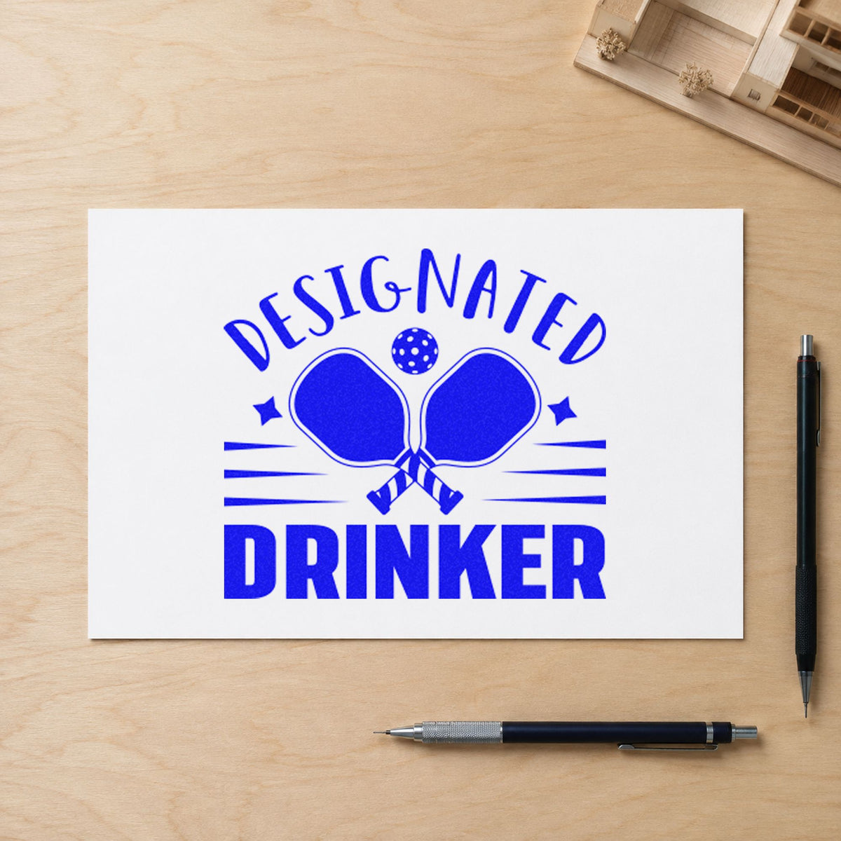 Designated Drinker Pickleball Paddles craft stamp imprinted in blue ink on paper, a design suited to framed club bar.