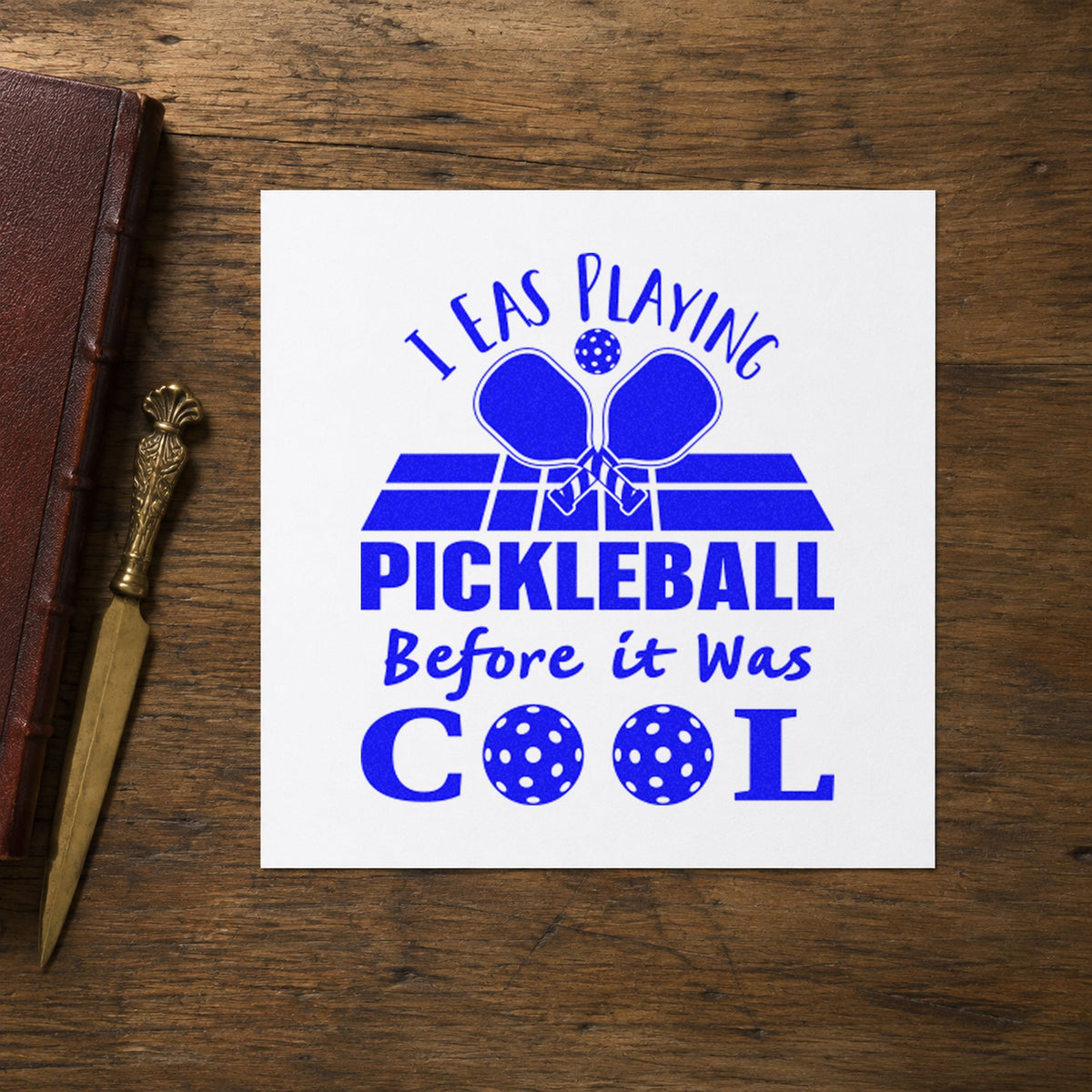 Pickleball Before It Cool craft stamp in blue ink on cardstock, an easy option for anniversary tee printing.