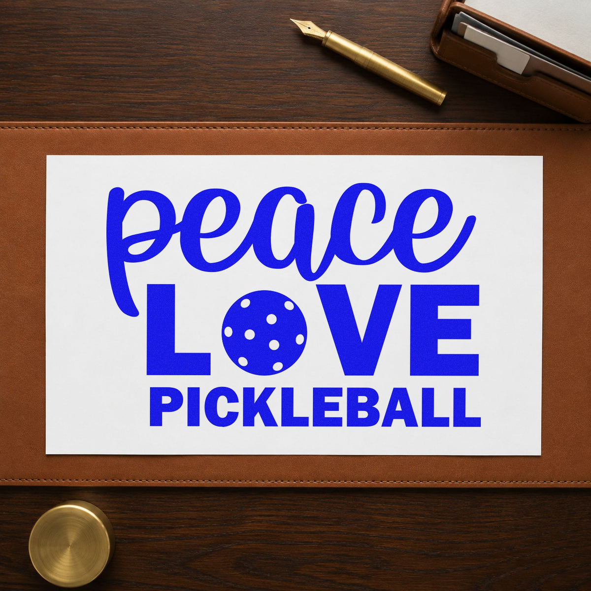 Peace Love Pickleball Lettering craft stamp imprinted in blue ink on paper, a design suited to framed entry tent.