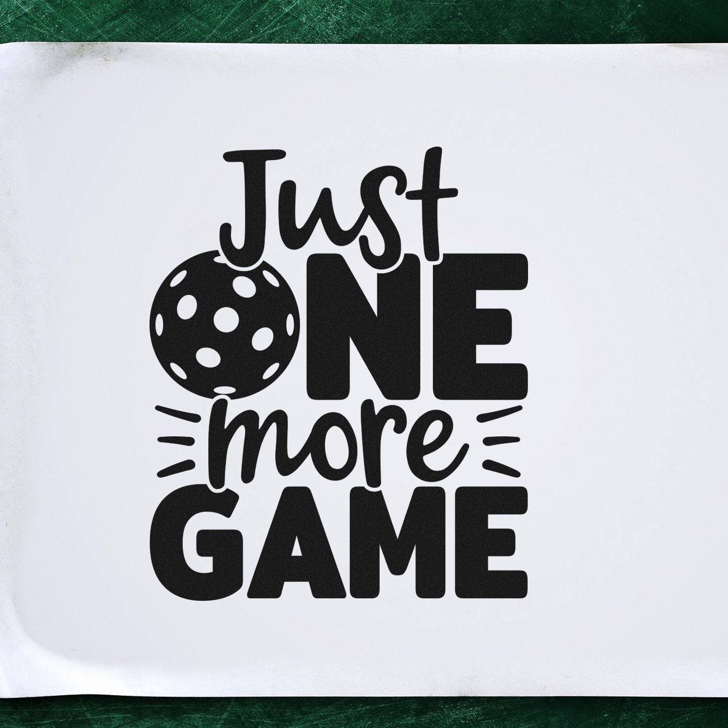 Just One More Game pickleball rubber stamp design with bold black text and ball graphic for sports crafts.