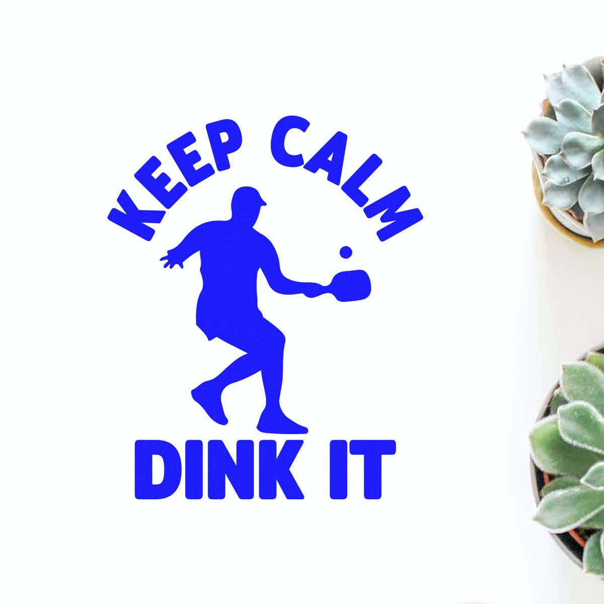 Keep Calm Dink It rubber stamp shown in blue ink, stamped for projects such as first event album page.