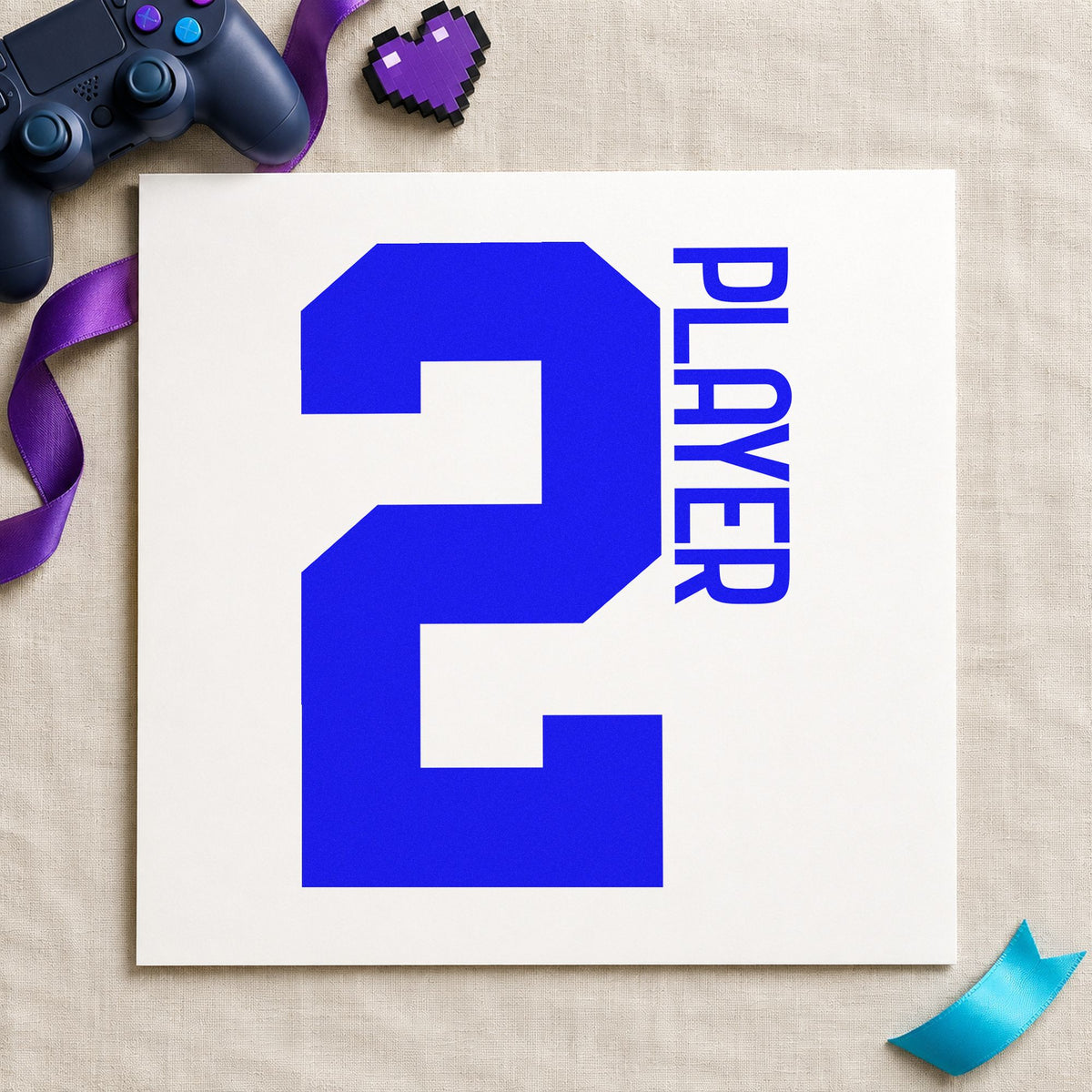 Player Two Bold Number craft stamp imprinted in blue ink on paper, a design suited to framed living corner.