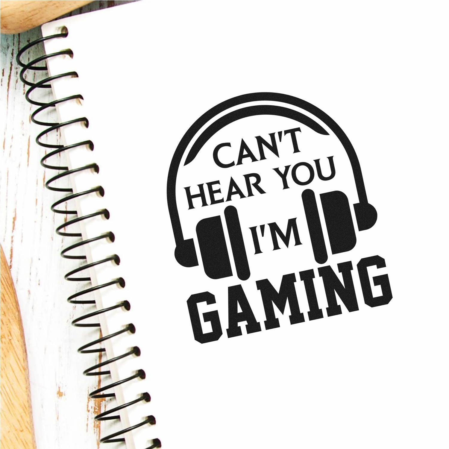 Gaming rubber stamp design with headphones and Cant Hear You Im Gaming text for gamer crafts, notebooks, and gifts.