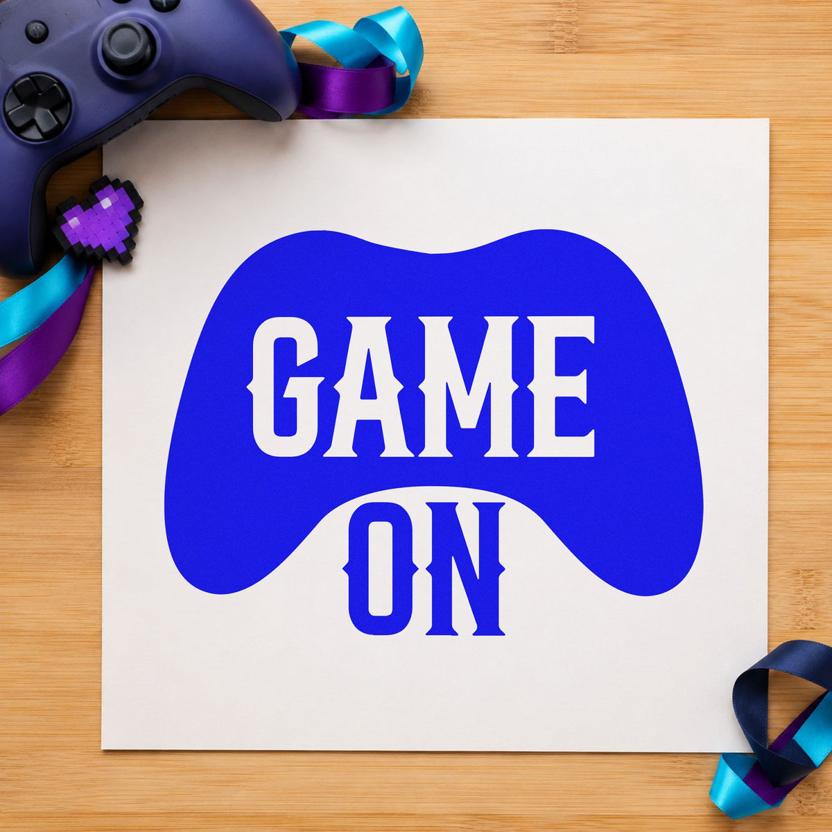 Game On Controller Silhouette craft stamp imprinted in blue ink on paper, a design suited to framed club lab.
