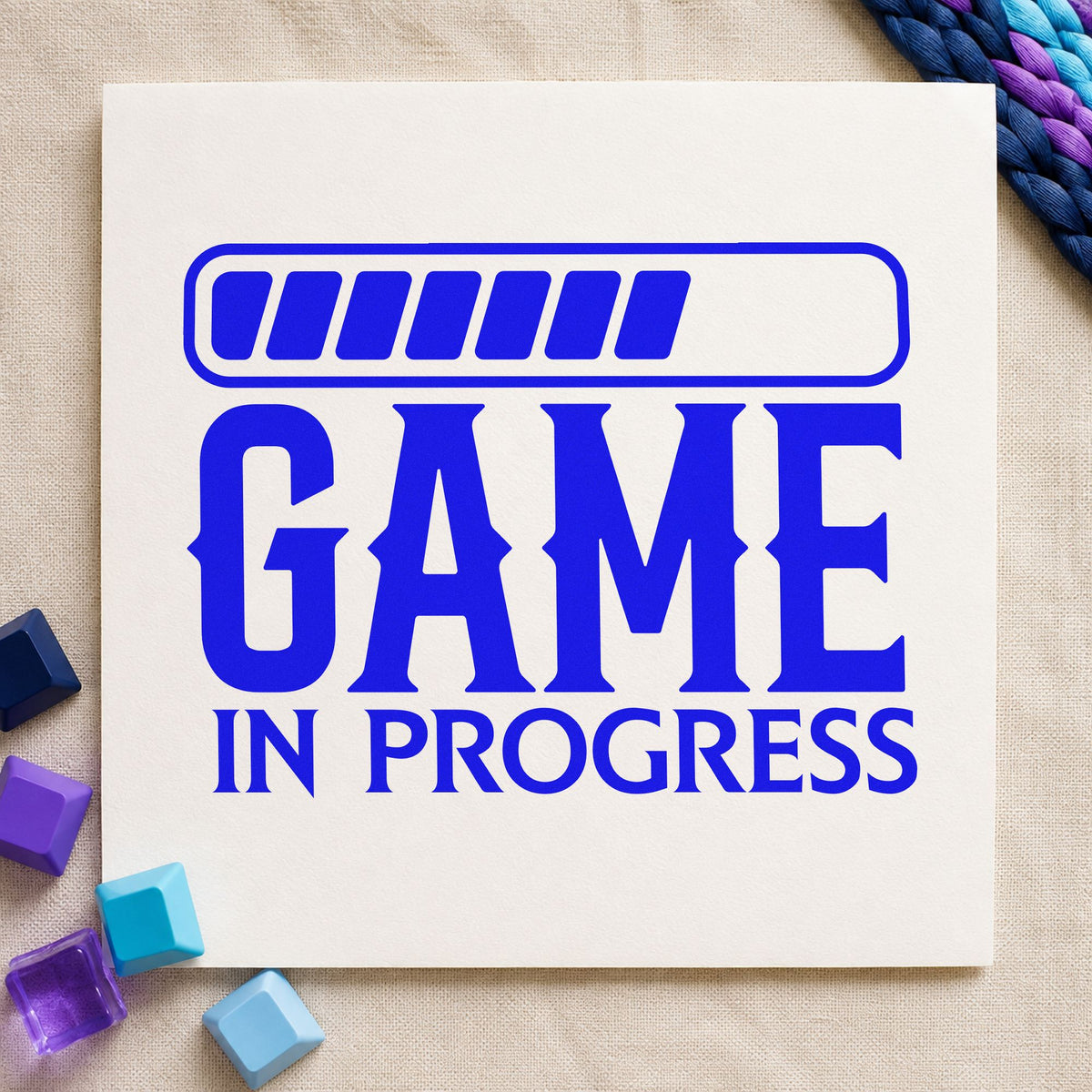 Game In Progress Loading craft stamp imprinted in blue ink on paper, a design suited to framed basement wall.