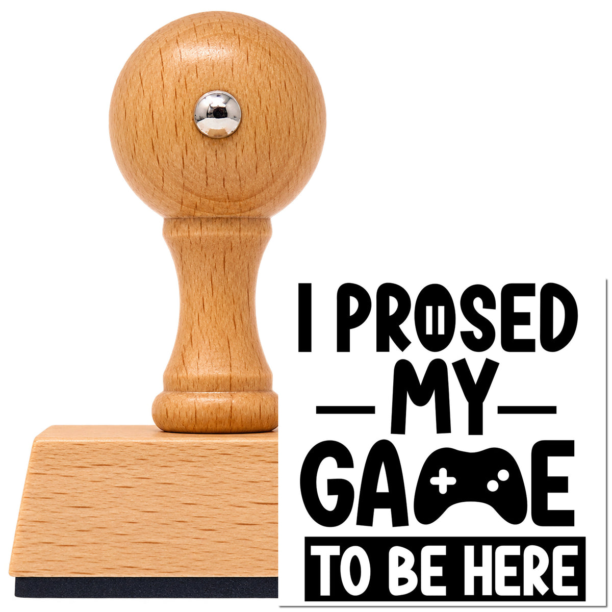 Gaming To Be Here Controller Lettering Vintage Pro rubber stamp in European beech wood with a round knob handle, shown beside its black imprint.