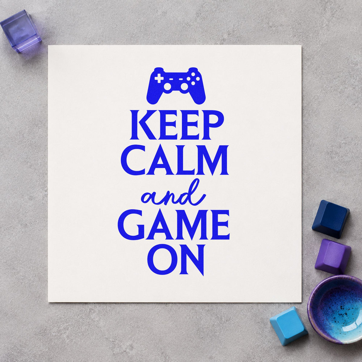 Keep Calm Game On craft stamp imprinted in blue ink on paper, a design suited to framed party corner.