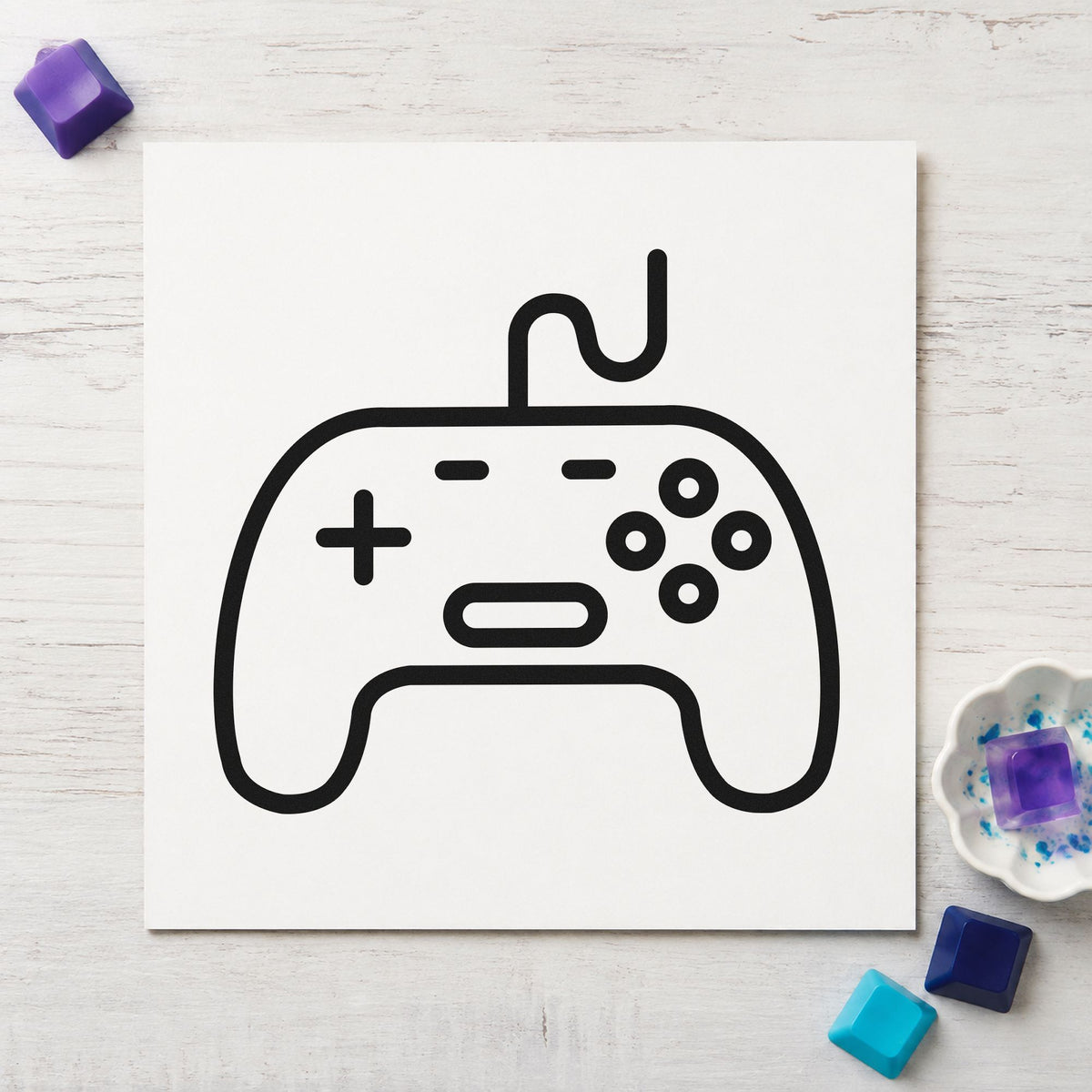 Outlined Wired Game Controller craft stamp imprint in black ink on a handmade project, one idea being traded game tags.