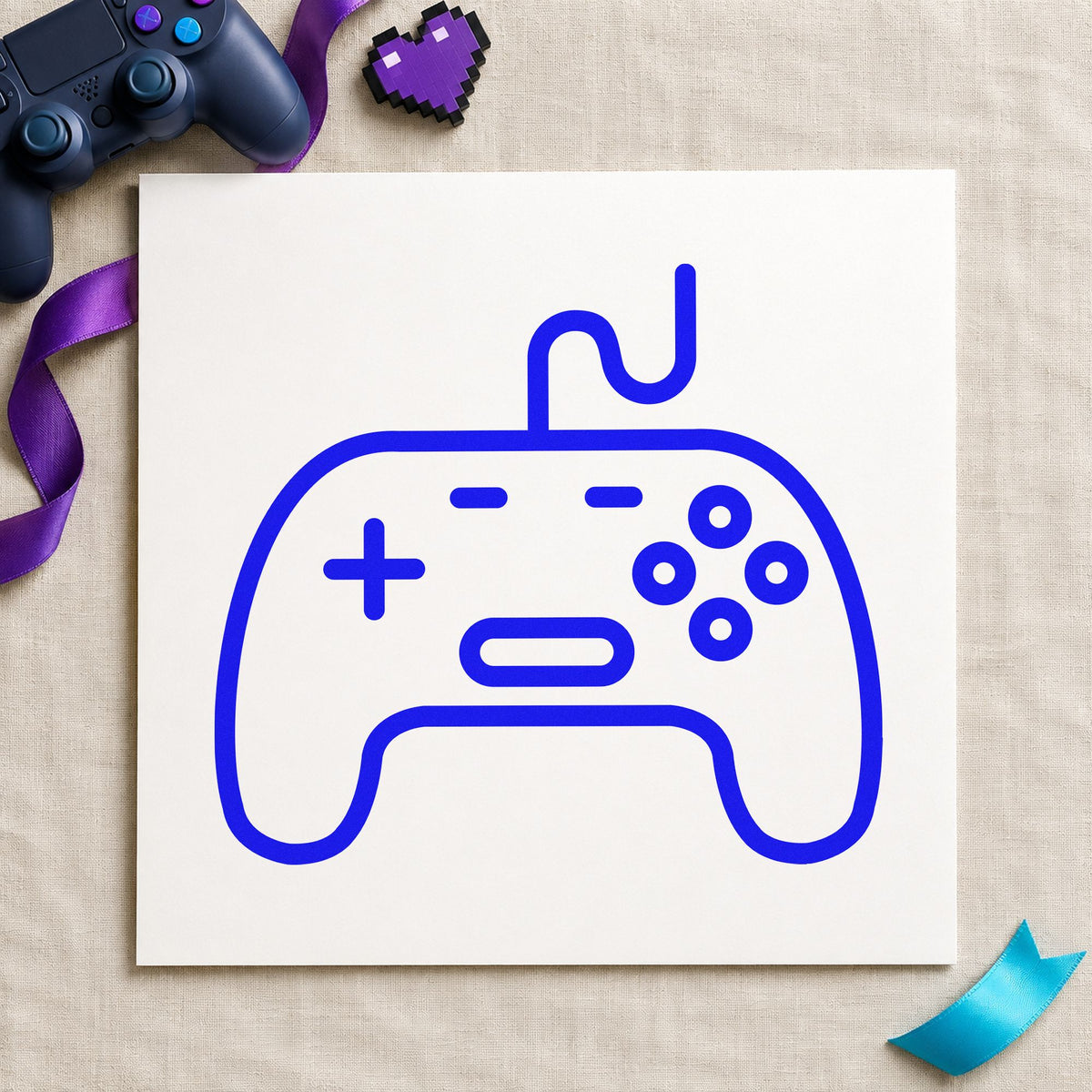 Outlined Wired Game Controller craft stamp in blue ink on cardstock, an easy option for display cloth printing.