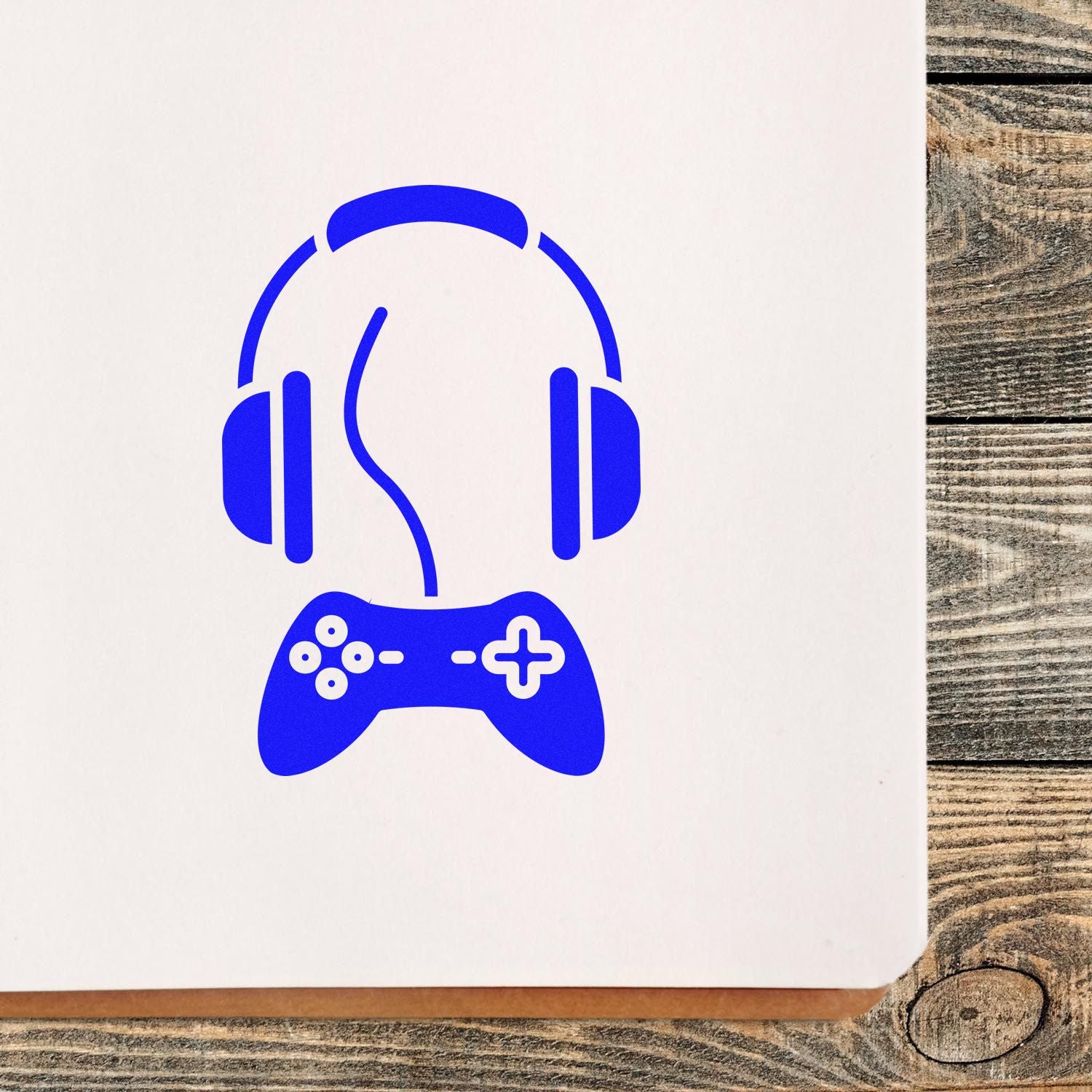 Custom rubber stamp design with blue gaming headset and controller icon, ideal for gamer logos, branding, or craft stamps.