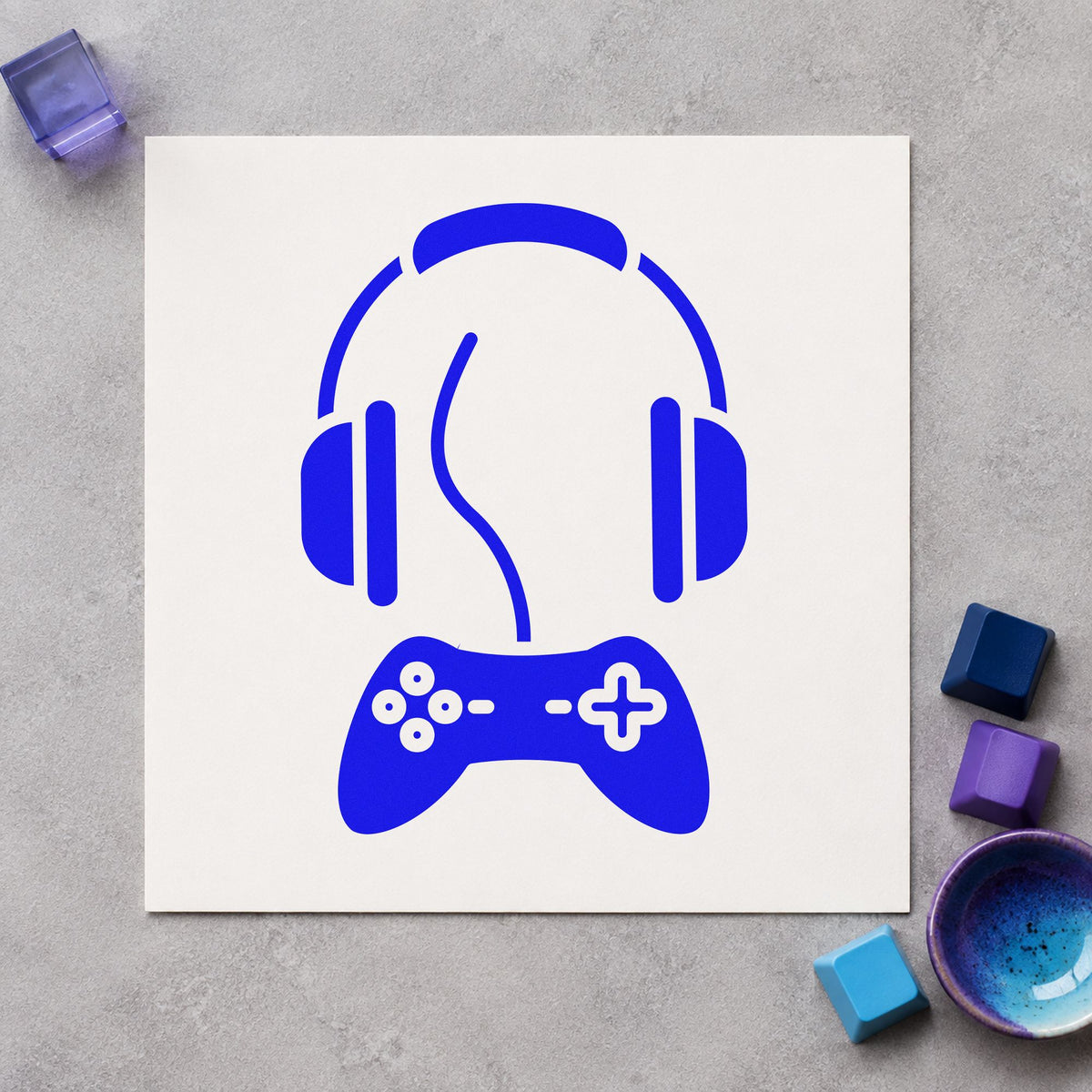 Headphones Above Wired Controller craft stamp imprinted in blue ink on paper, a design suited to framed booth corner.