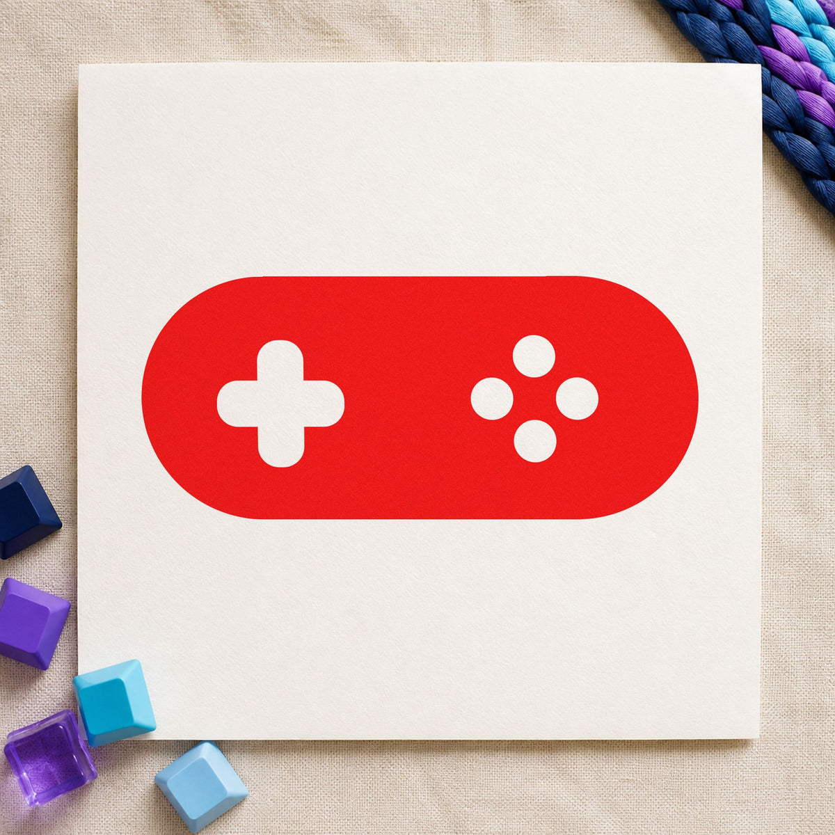 Rounded Retro Game Controller craft stamp imprint in red ink on a handmade project, one idea being high score cards.