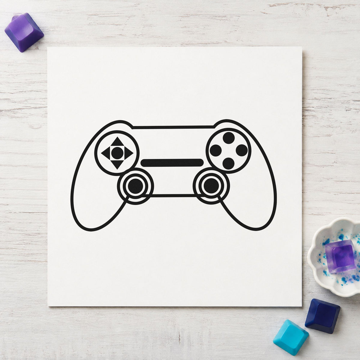 Outlined Dual Stick Controller craft stamp imprint in black ink on a handmade project, one idea being build copy gift tags.