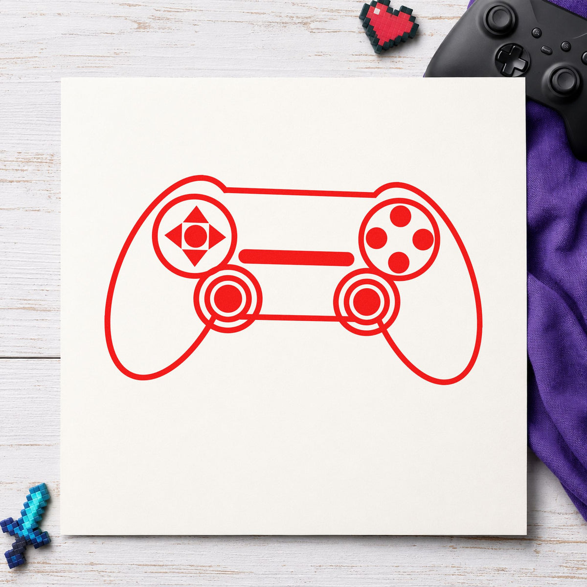 Outlined Dual Stick Controller craft stamp imprint in red ink on a handmade project, one idea being playtest note cards.