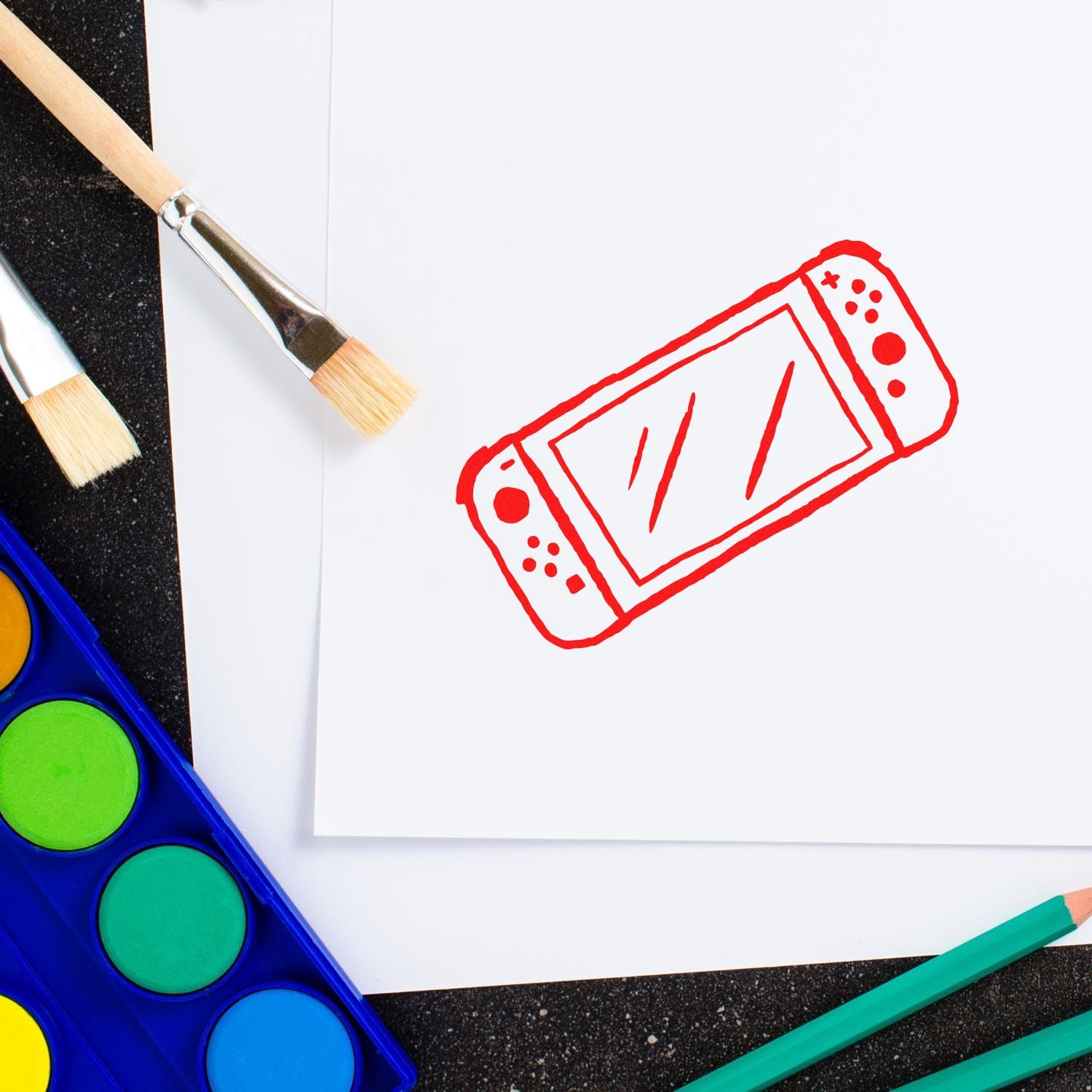 Custom rubber stamp design featuring a red smartphone icon on paper with paintbrushes and watercolor paints.