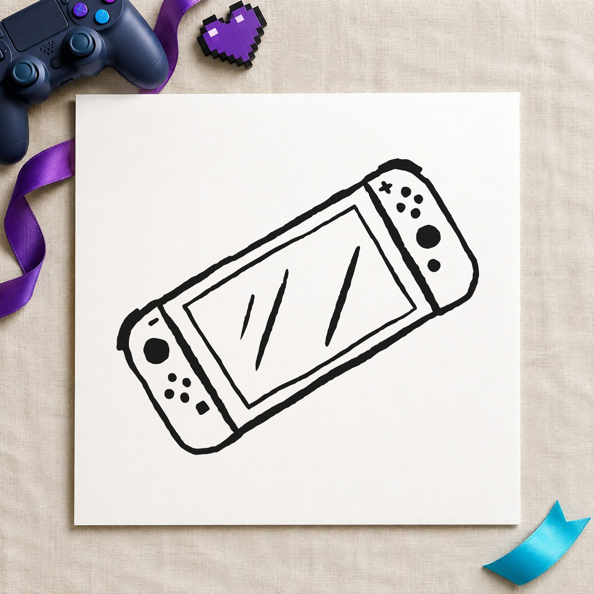 Handheld Gaming Console Outline craft stamp imprint in black ink on a handmade project, one idea being travel case gift tags.